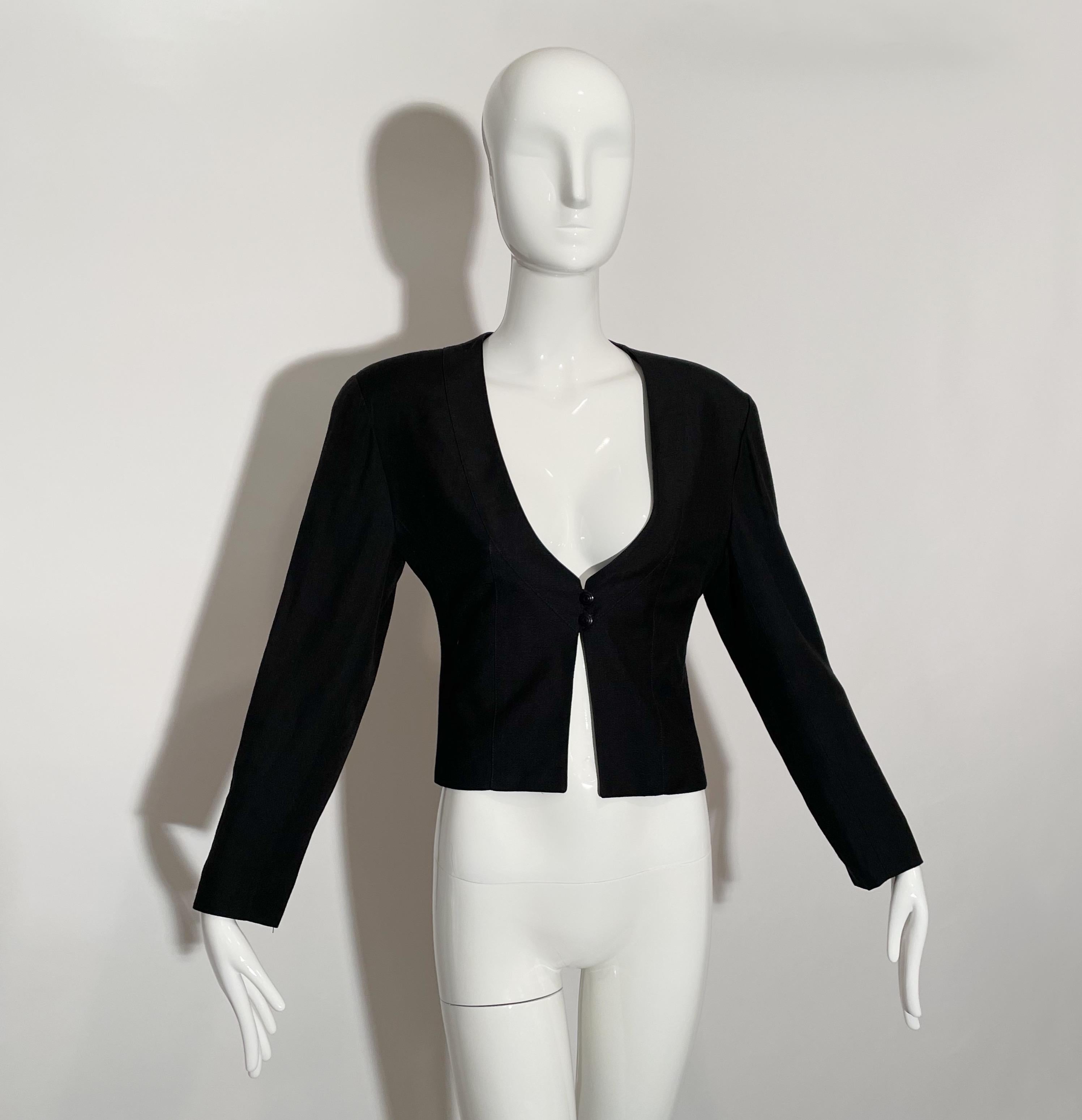 Black cropped blazer. Plunging neck line. Front button blosure. Lined. Viscose and linen. Made in France.

*Condition:  excellent vintage condition. No visible flaws.

Measurements Taken Laying Flat (inches)—

Shoulder to Shoulder: 16.5