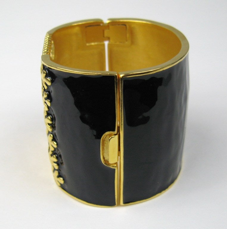 Massive  Lagerfeld Cuff, New Old Stock. Hallmarked KL Black enamel with Gold Cris Cross Corset Motif. Measures 2.10 in /53.49mm wide. Hinged opening. Large Statement piece that was purchased New stored away. This is a stunning piece of Lagerfeld.
