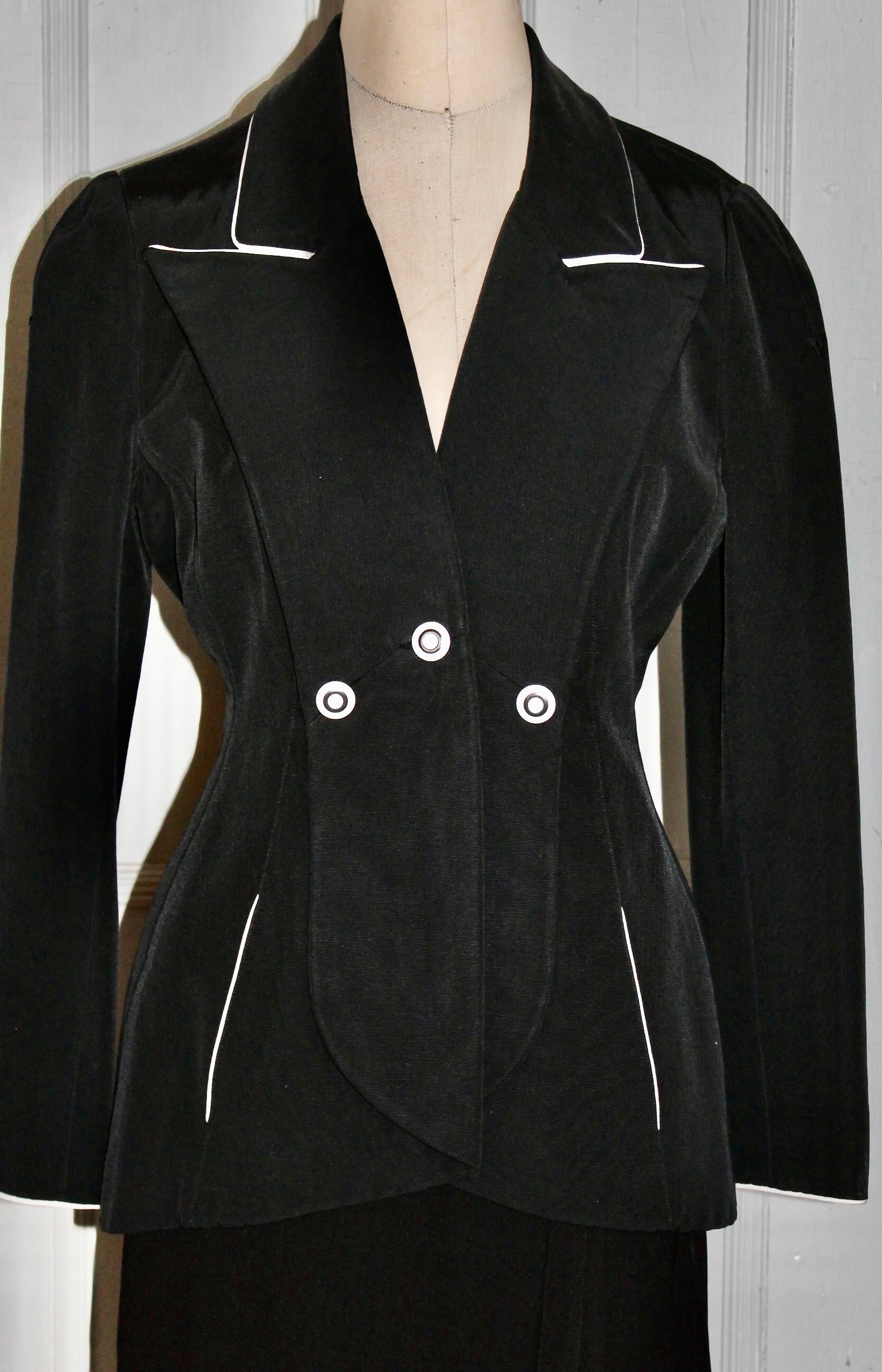 A Karl Lagerfeld Made in France, Classic black with white buttons and white trim jacket.  Pockets.  Appears to be a silk blend.