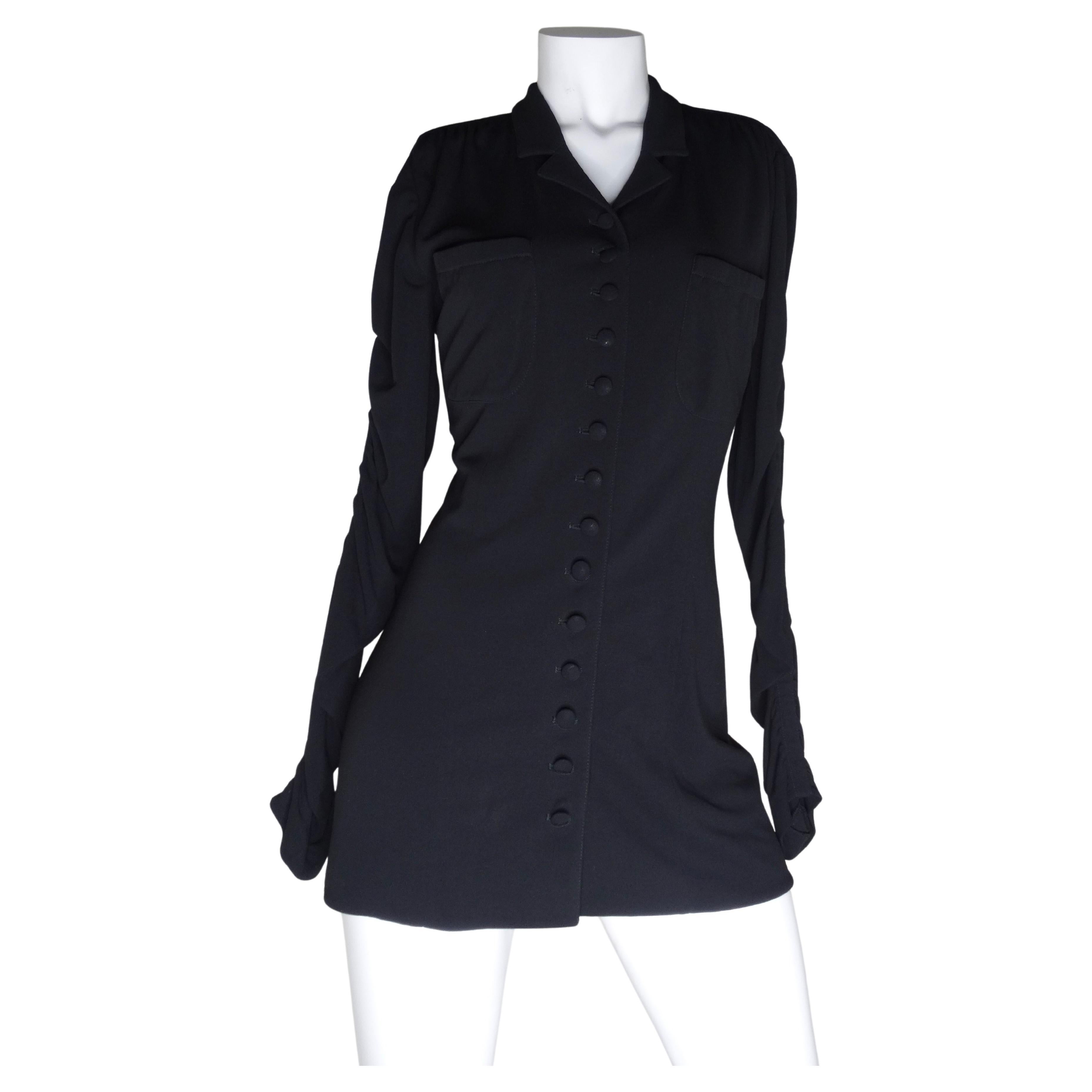 Iconic Karl Lagerfeld button down! Featuring a structured collar, two breast pockets and shoulder pads, this piece is as functional as it is versatile. The sleeves are fully ruched which adds such a fun flare to the otherwise classic and effortless