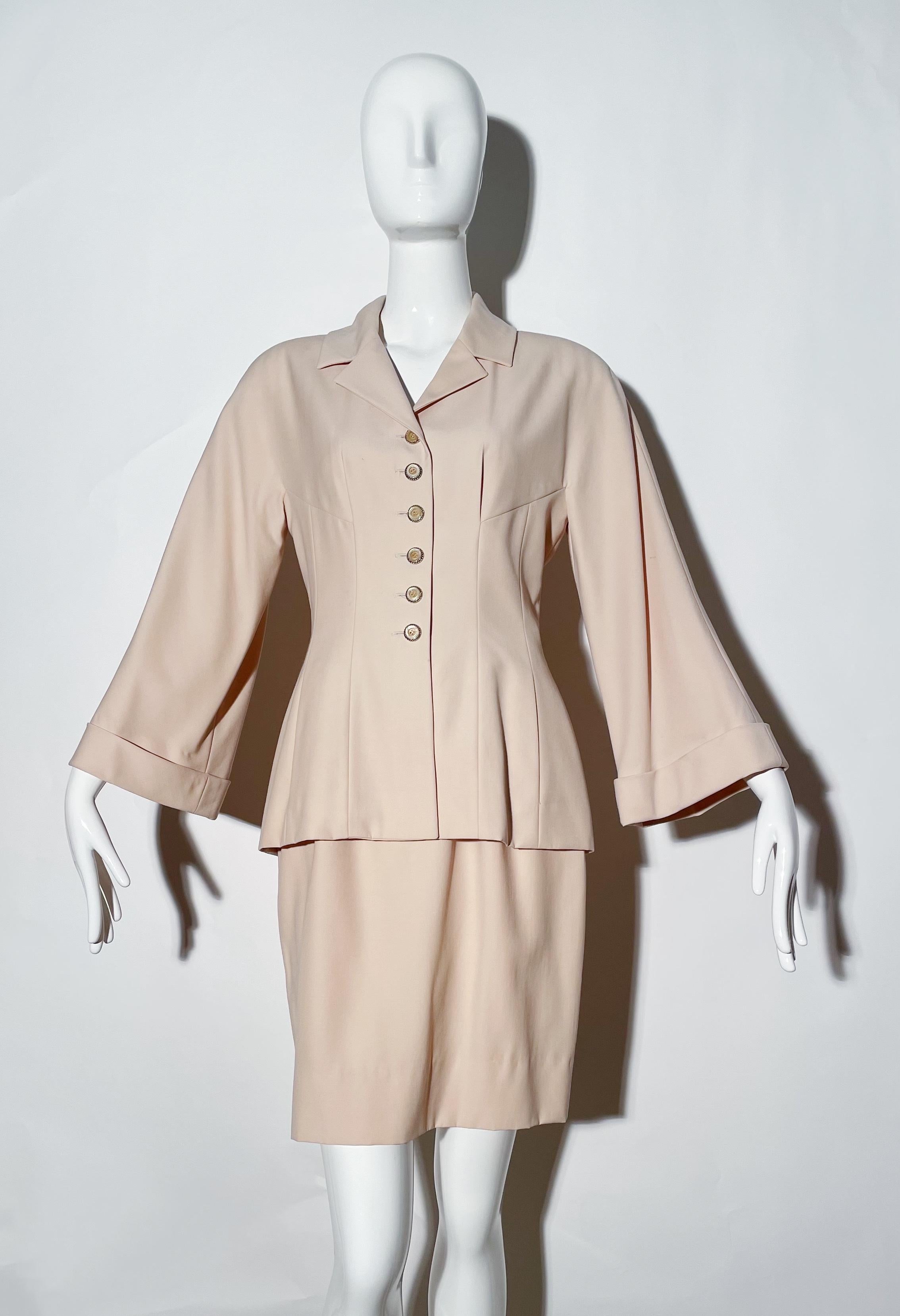 Blushy beige colored skirt suit. Front button closures. Shoulder pads. Collared. Fitted style. Rear zipper on skirt. Lined. Wool. Made in France. 
*Condition: Excellent vintage condition. No visible Flaws.

Measurements Taken Laying Flat