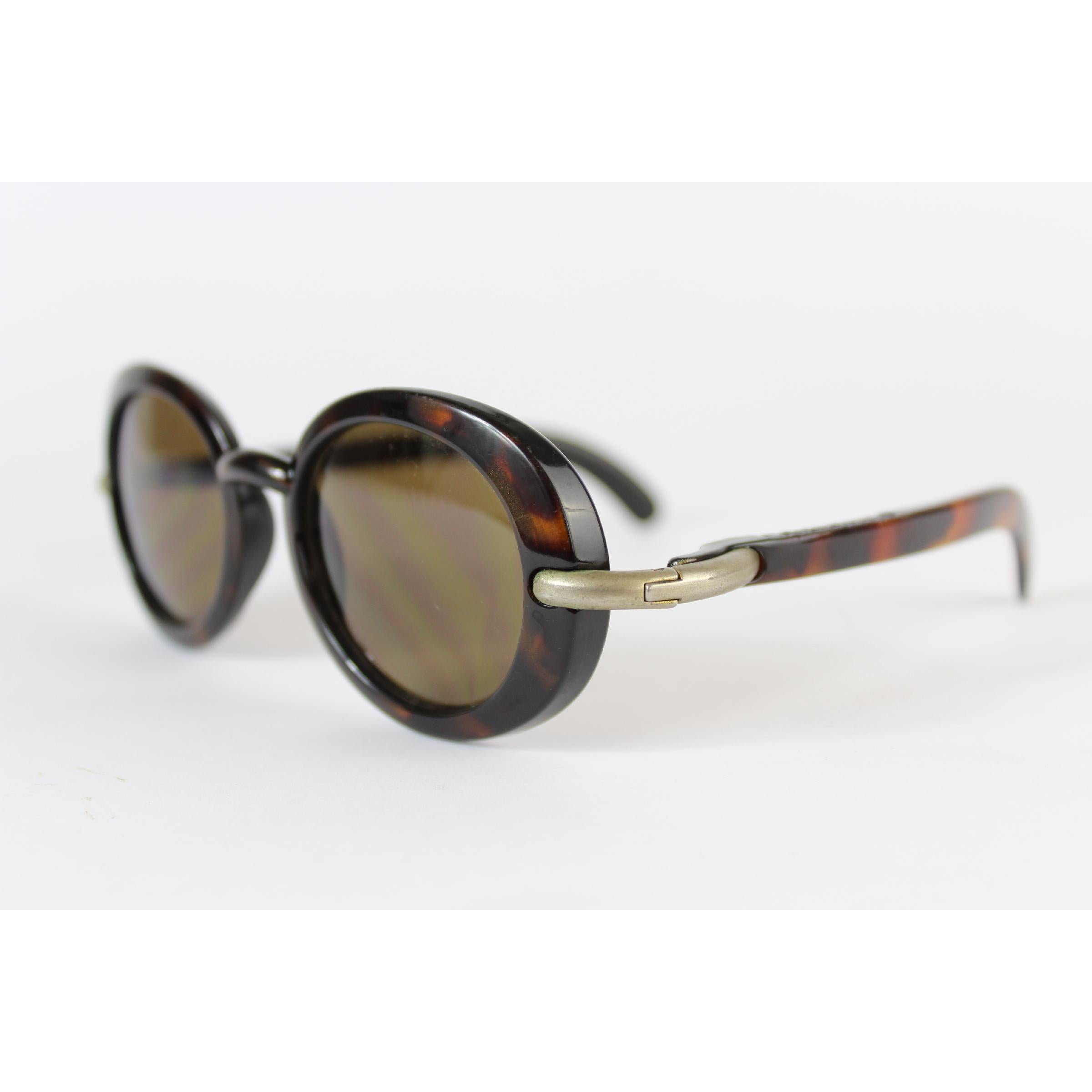 Karl Lagerfeld vintage women's sunglasses 90s. Round model, tortoise-brown color, PC Cridalon lenses. Made in France. The lenses have some little signs of use, in the whole the conditions are excellent. 
Presumably model: 411501, unfortunately it is