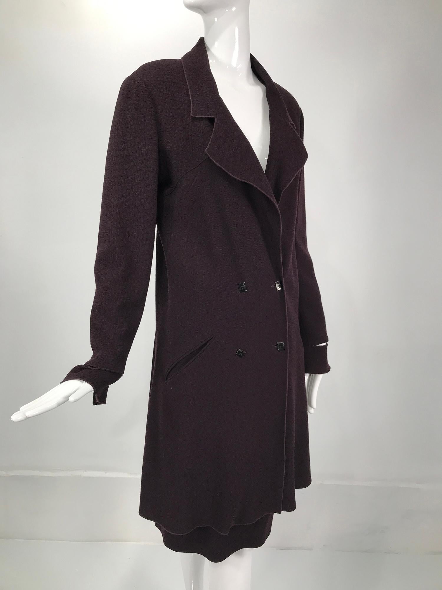 Karl Lagerfeld burgundy wool crepe coat & skirt set from the 1980s. Double breasted coat has notched lapels, serged facings and closes with silver metal logo buttons. All the facings are serged finished. The coat has angled besom hip pockets. The