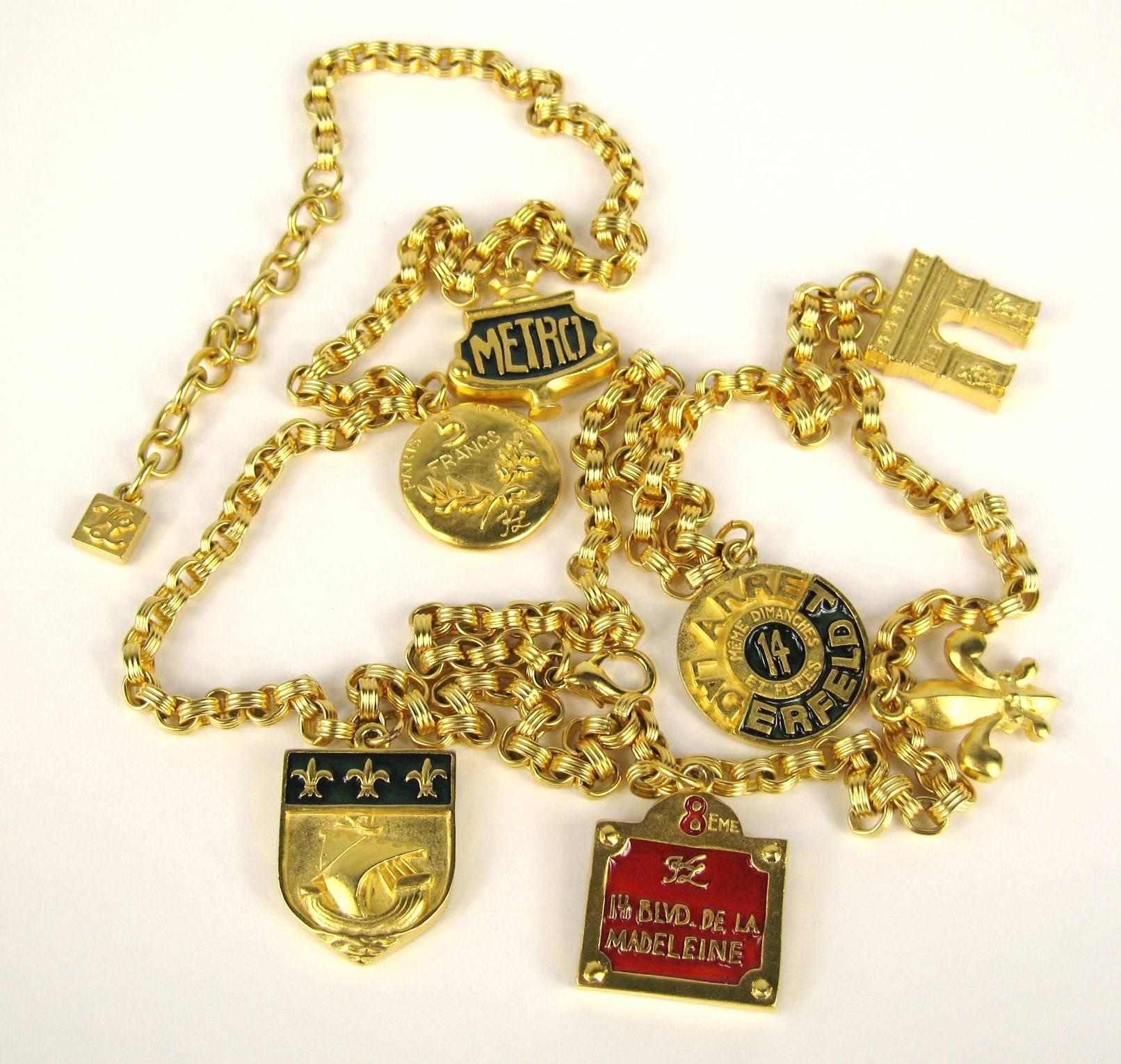 Karl Lagerfeld Gilt metal with Red Enamel with the words 14 Blvd De La Madeleine Charm Necklace or belt. Charms include 14 Blvd De La Madeleine/ 5 francs/ meme dimanchie et petes / Metro. I have more of this set listed on my storefront. It  measures