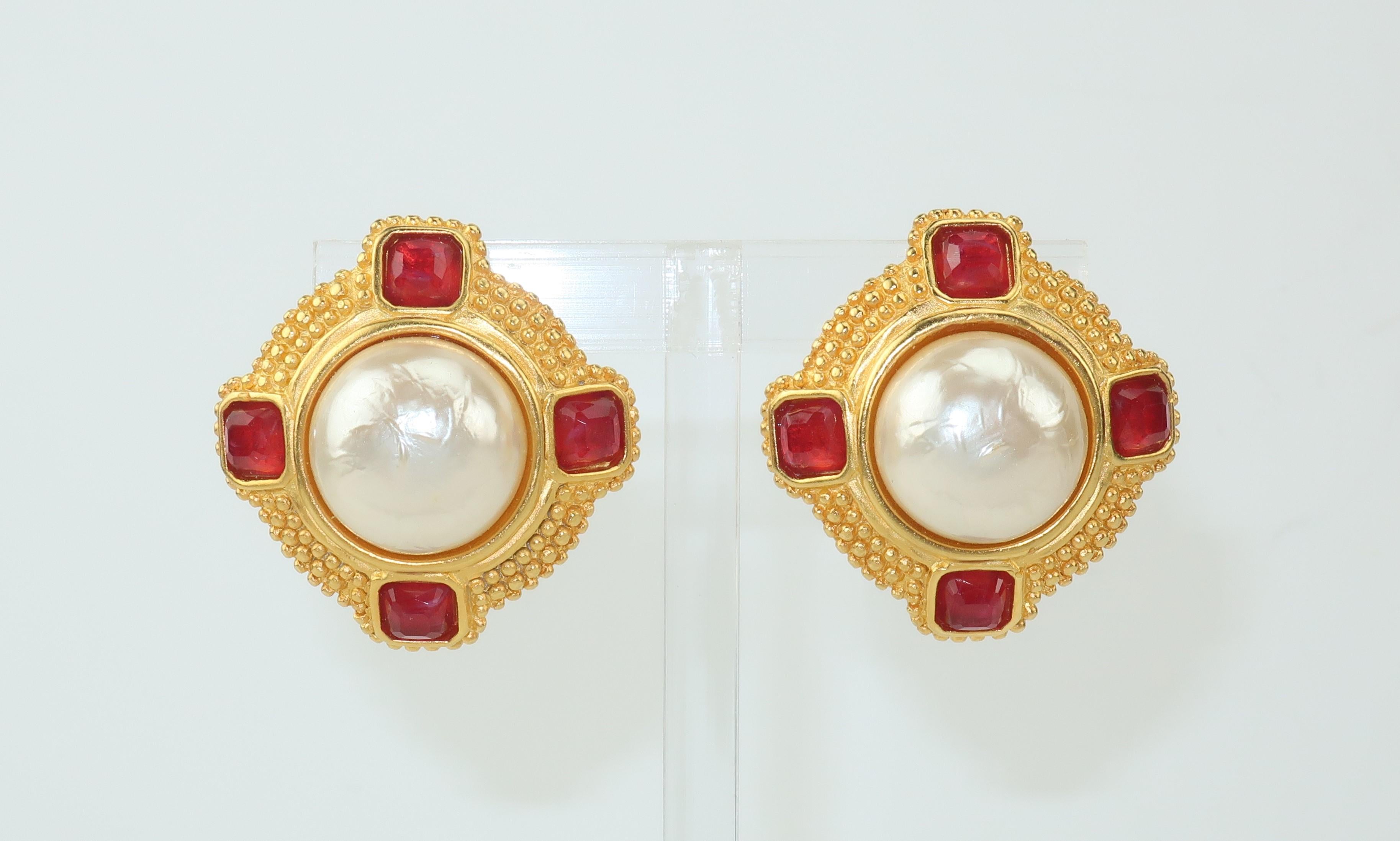 A chic pair of Karl Lagerfeld clip on earrings with faux mabe pearls accented by faceted amber color crystals set in a matte gold tone setting with a beaded design.  A classic design that will pair well with Lagerfeld or Chanel ensembles.  Signed