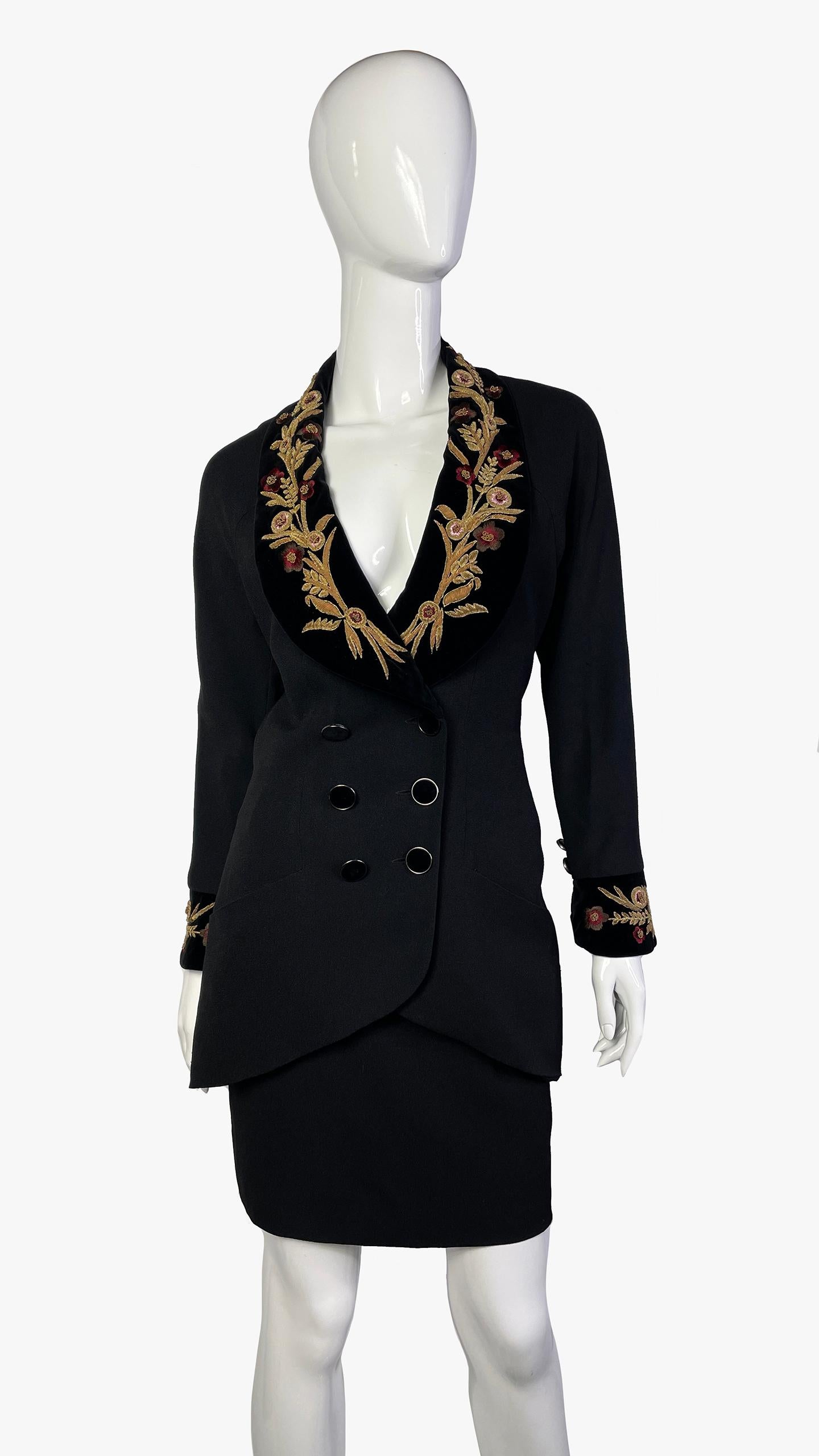 Incredible Fall-Winter 1990 Karl Lagerfeld runway black skirt suit featuring metal embroidery work over velvet detailing on the blazer

Double breast front with large velvet buttons, with the embroidery work on the lapel and the cuffs. Paired with a