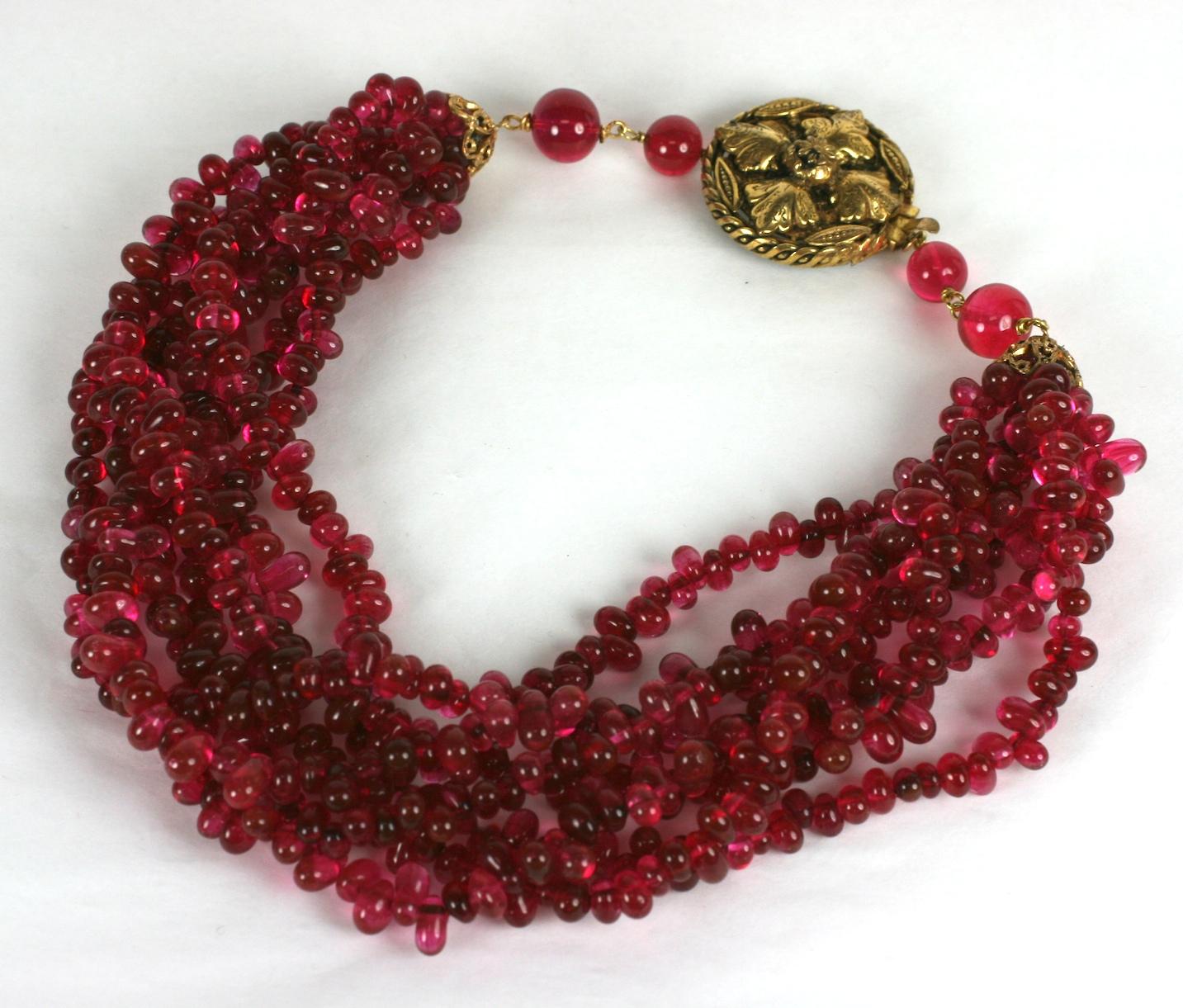 Rare Karl Lagerfeld for Chanel 1983 Indian pink ruby pate de verre torsade necklace from his first collection for Chanel. 7 strands of vari sized and shaped hand made Maison Gripoix beads with ornate bronze clasp.
17