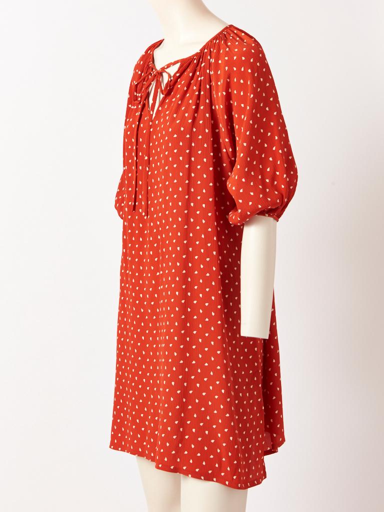 Karl Lagerfeld, for Chloé,  small patterned, brick red, peasant stye, tunic, in a light weight, crinkled silk, with 3/4 balloon sleeves and a tie at the neckline.