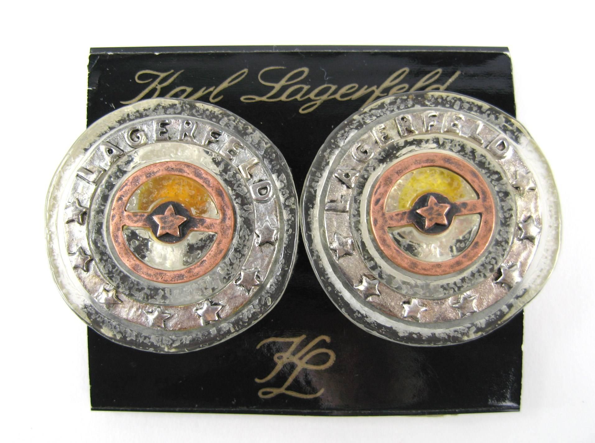 Large Karl Lagerfeld Disc earrings New Old Stock. Lucite with copper colored center, with the monogrammed surrounding. Measuring about 1.5 inches in diameter. This is out of a massive collection of Contemporary designer clothing as well as Hopi,