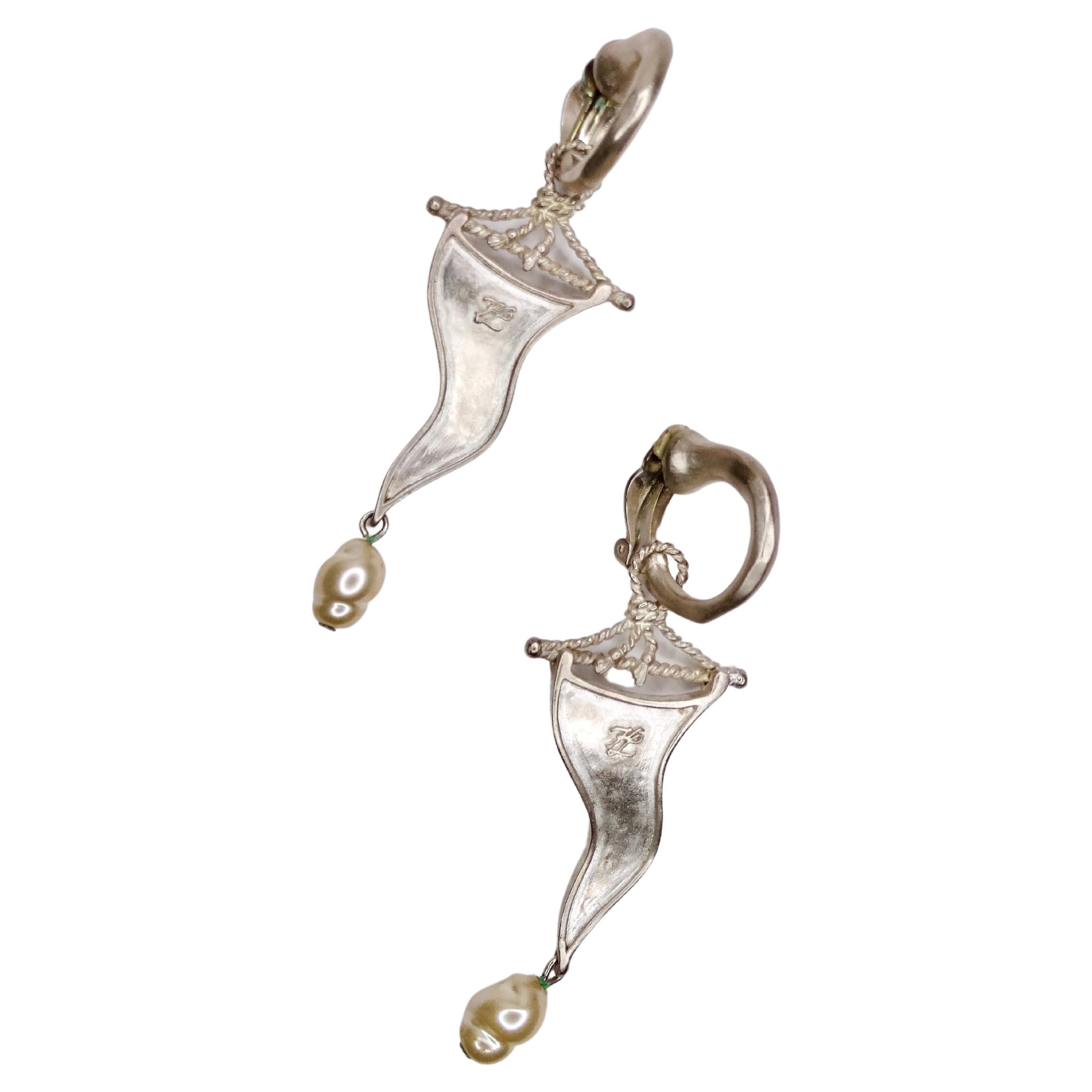 Keep a piece of Karl Lagerfeld close to your heart by getting these fun and flirty costume collection earrings. It features a metal flag with intricate rope detailing and a dainty pear dangling from the bottom. When searching for the perfect earring