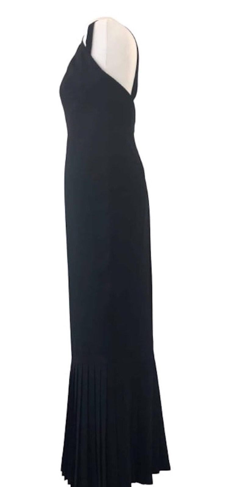 A stunning KARL LAGERFELD PARIS Black Long Evening Dress Circa 2000 with a V-neck, thin straps, a sleeveless gowns design, 2 small buttons closure in the neck with an invisible zip, ruffle pleated at the bottom, a very chic sheath silhouette. Feel