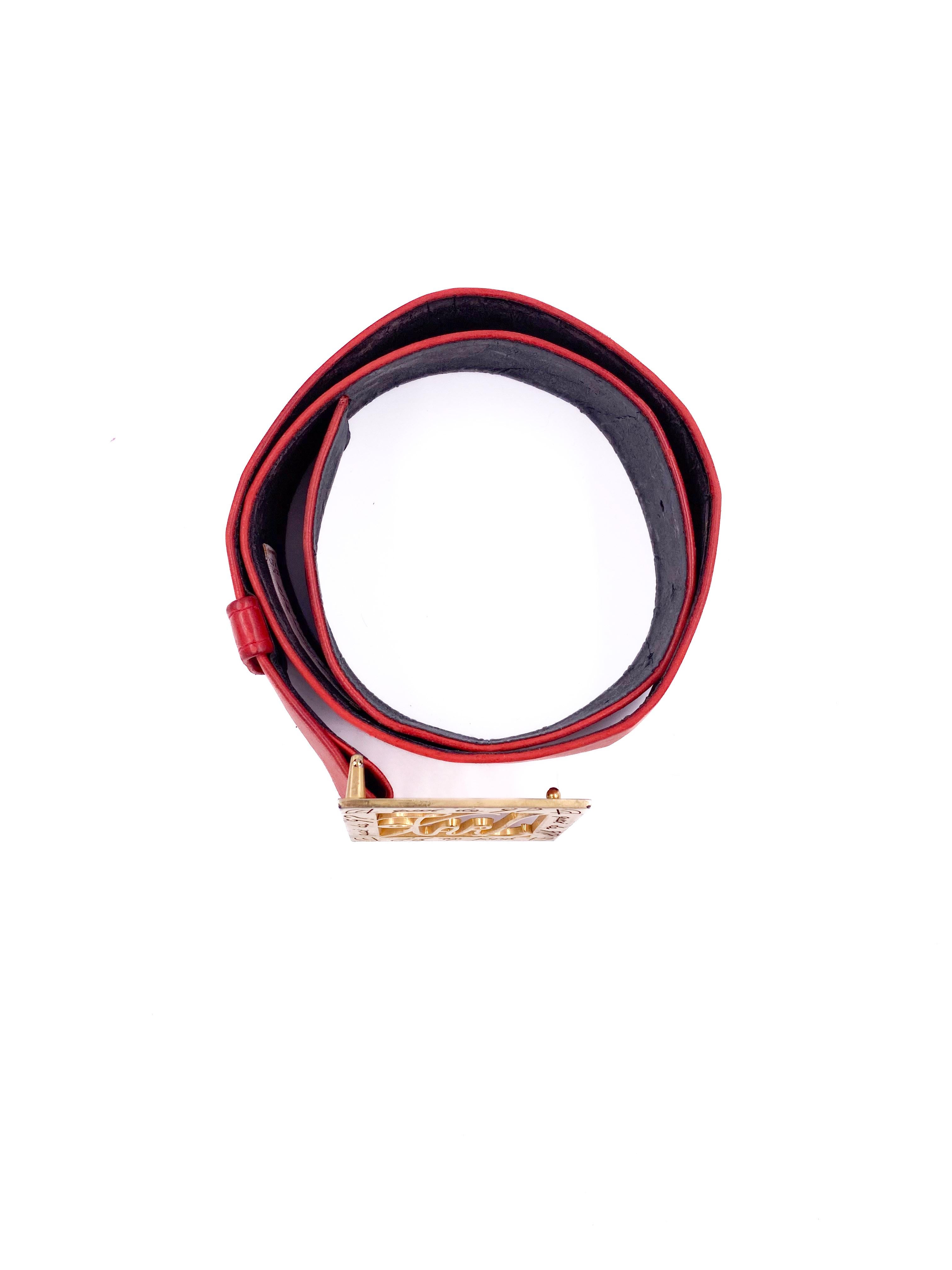 Aggiungi un tocco di lusso al tuo abbigliamento con la cintura in pelle rossa di Karl Lagerfeld. Questa cintura larga, disegnata dalla famosa icona della moda, è caratterizzata da una fibbia d'oro incisa che aggiunge un tocco di classe a qualsiasi