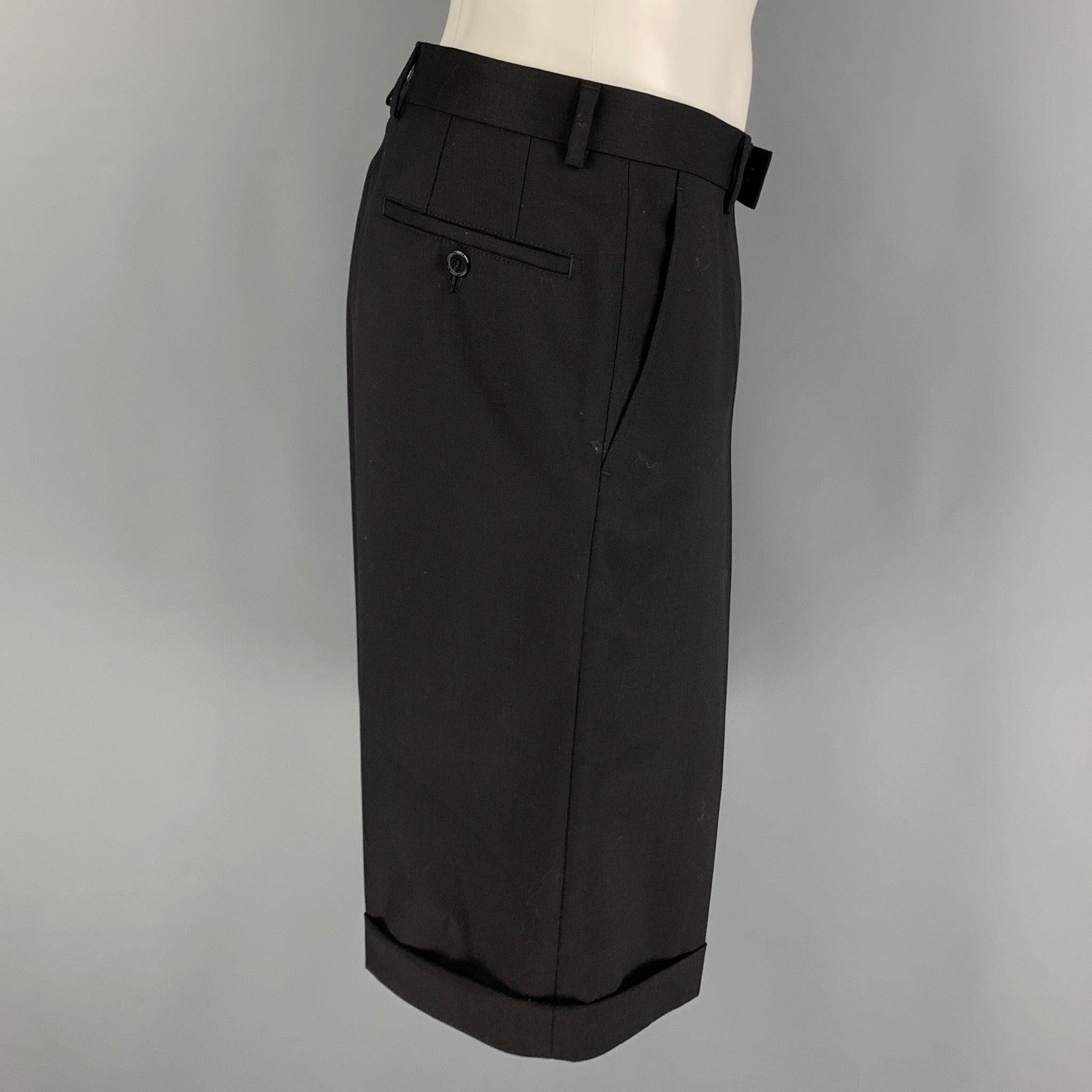 KARL LAGERFELD shorts come in a black wool and elastane twill material with a flat front, folded cuffs, and zipper fly.Excellent Pre-Owned Condition.  

Marked:   52 

Measurements: 
  Waist: 35 inches Rise: 8.5 inches Inseam: 13 inches 
 
  
  
