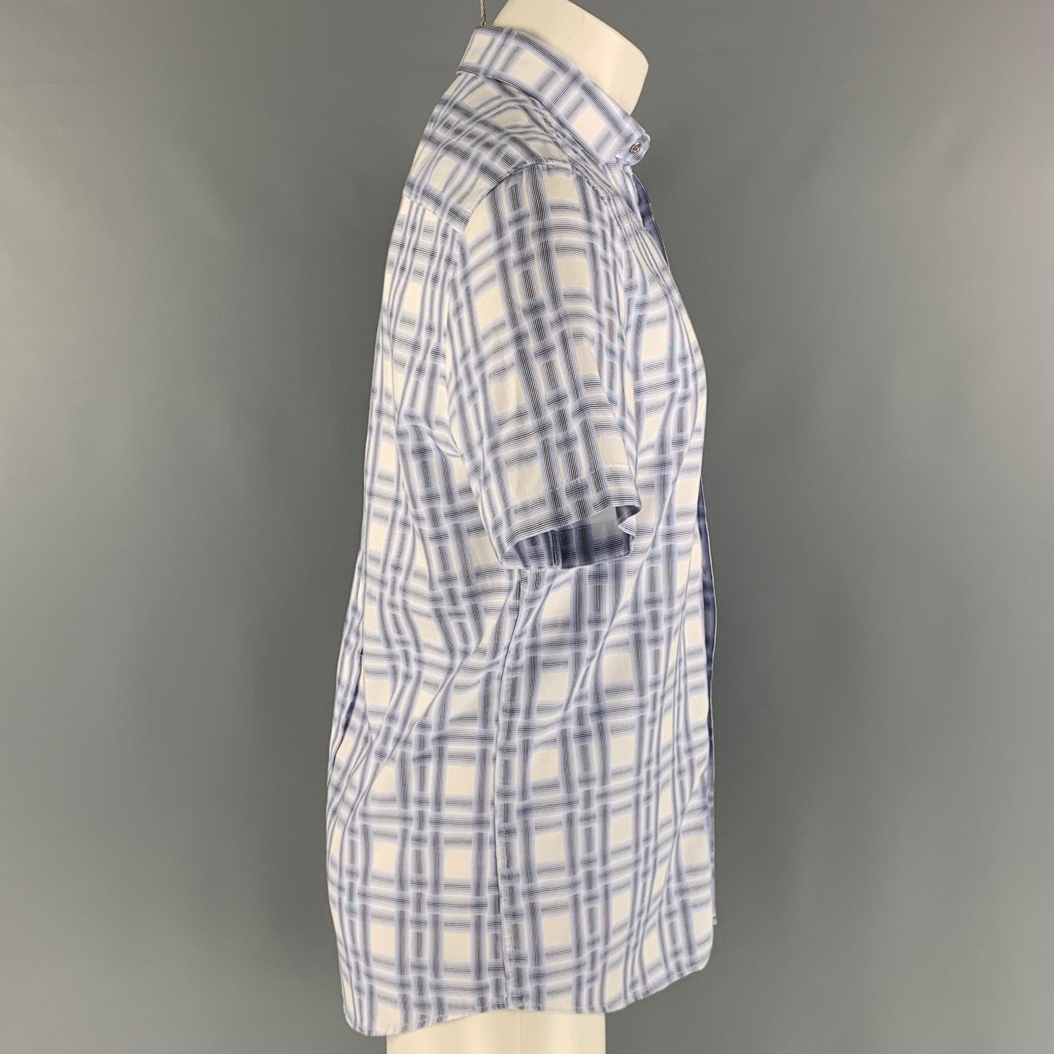 KARL LAGERFELD short sleeve shirt comes in a white and blue print cotton woven material featuring a snap button closure. Very Good Pre- Owned Conditions. 

Marked:   M 

Measurements: 
 
Shoulder: 18 inches Chest: 42 inches Sleeve: 9.5 inches