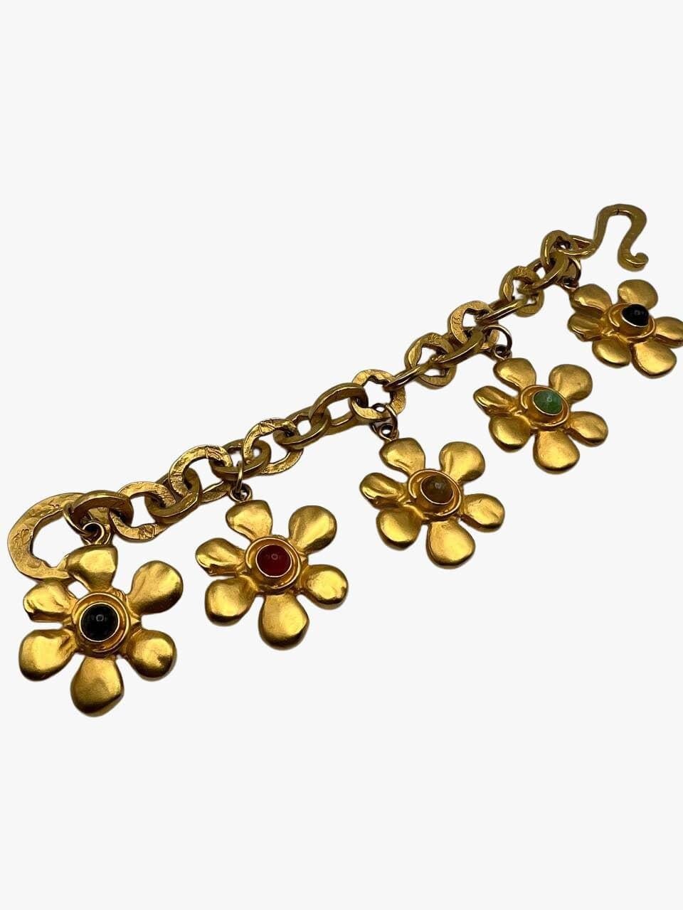 Vintage Karl Lagerfeld 24k gold plated bracelet features 5 oversized dangling daisy flowers centered with glass cabochons, each different color. 
KL monograms on each link. 

Signed.

Period: 1980s

Condition: excellent. No visible signs of wear.