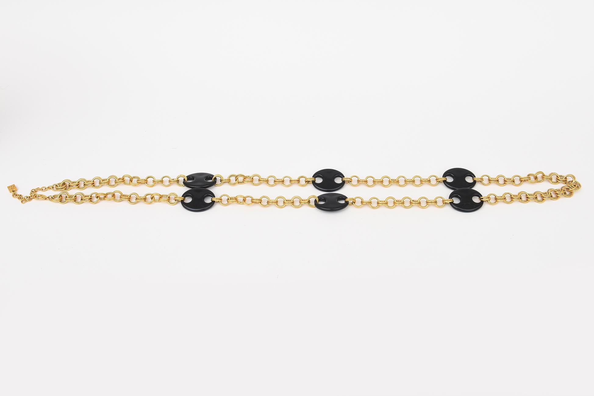 This fabulous and arresting vintage 1980's Karl Lagerfeld necklace is called the mariner necklace and wraps many times over on the neck or can be staggered. It is a brass metal chain called rolo links of 2 intertwined circles with interspersed black