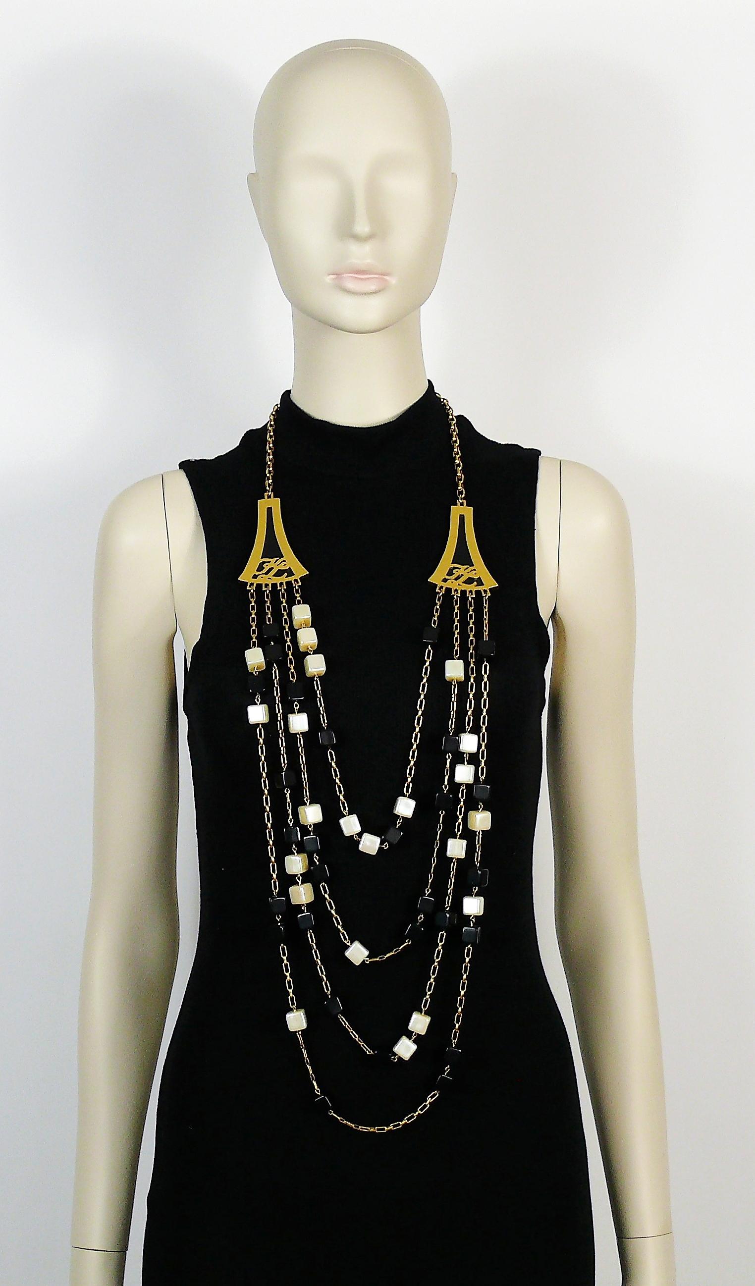 KARL LAGERFELD vintage four strand gold toned sautoir necklace featuring black/iridescent off-white resin cubes, gold toned chains and 2 large KL monogram elements embellished with black perspex on both sides.

Adjustable lobster clasp closure.

KL