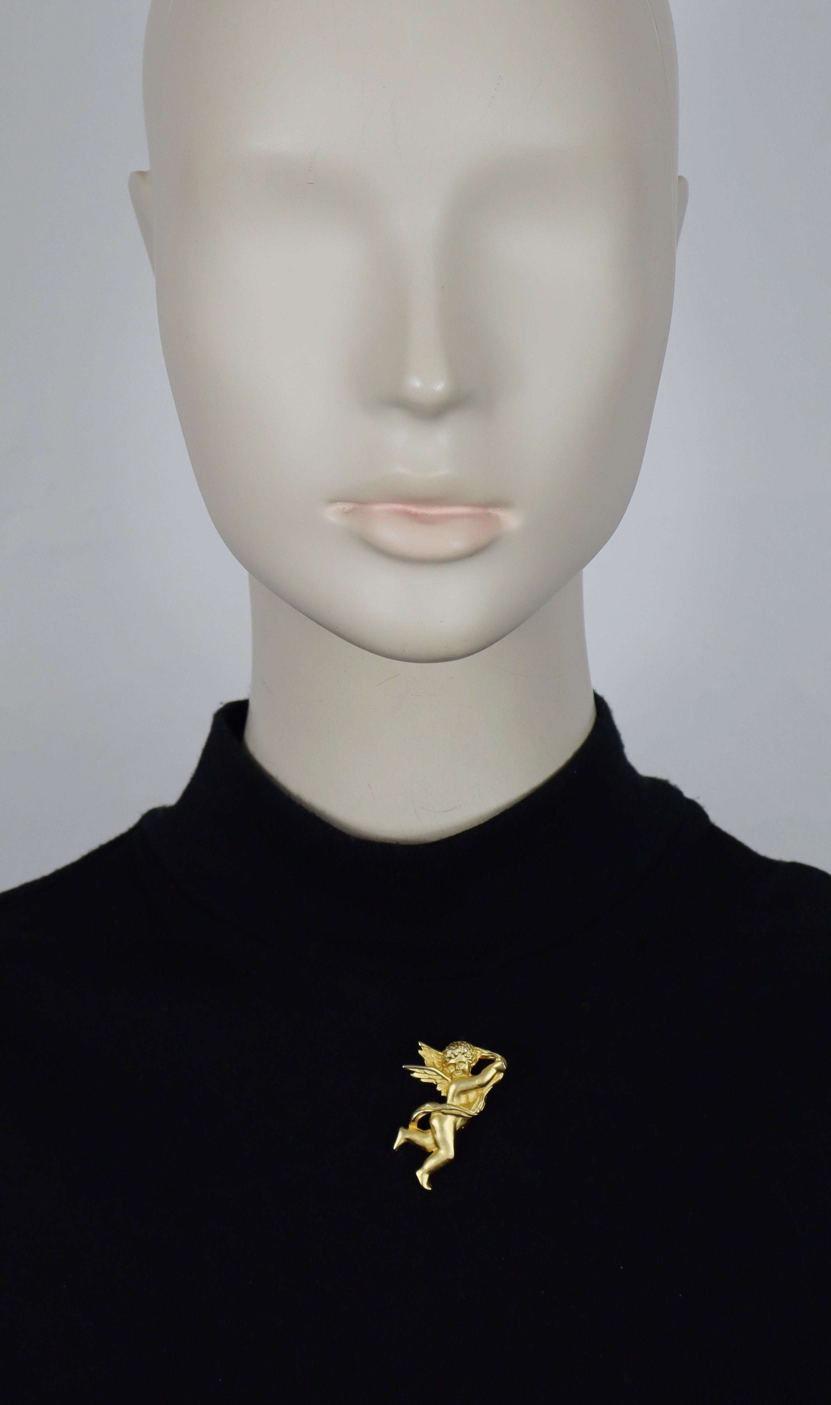 Broche querubín vintage en tono dorado mate KARL LAGERFELD.

KL en relieve.

Medidas orientativas: longitud máx. aprox. 3,8 cm / altura máx. aprox. 2,3 cm.

Material(es) : Herrajes metálicos en tono dorado.

NOTAS
- Se trata de un artículo vintage