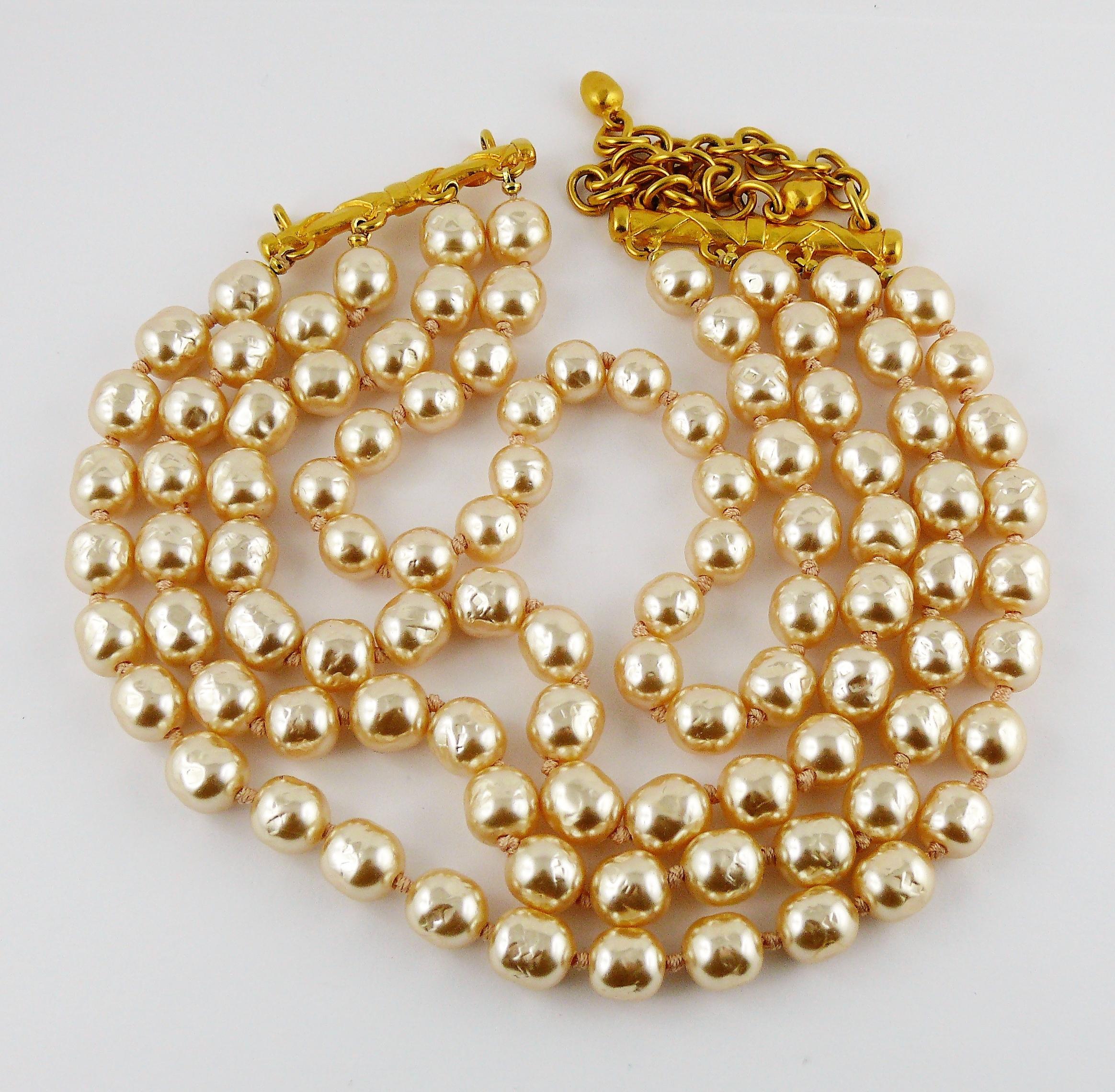 KARL LAGERFELD vintage four tiered glass pearl strands choker necklace.

Gold toned hardware.

Pearl color is hard to describe, but to our opinion, the nearest color could be powder apricot.

Adjustable hook closure.

Embossed KL.

Indicative