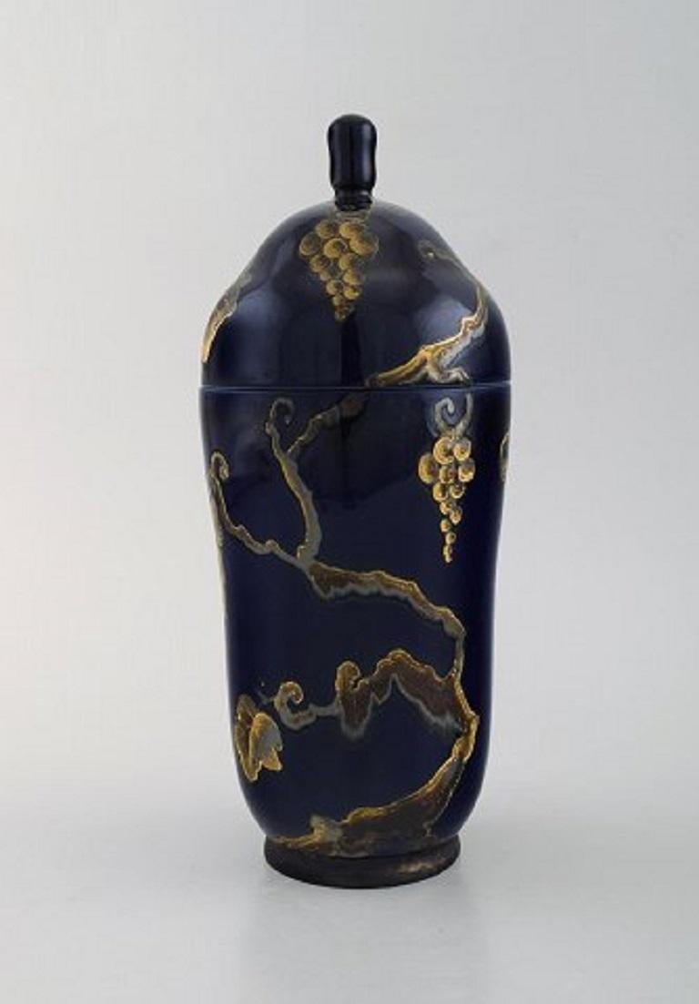 Karl Lindström and Nils Emil Lundström for Rörstrand. Lidded porcelain jar decorated with grape vines in gold on a beautiful dark blue base. Japanism, circa 1920.
In very good condition.
Measures 25 x 10.5 cm.
Stamped.