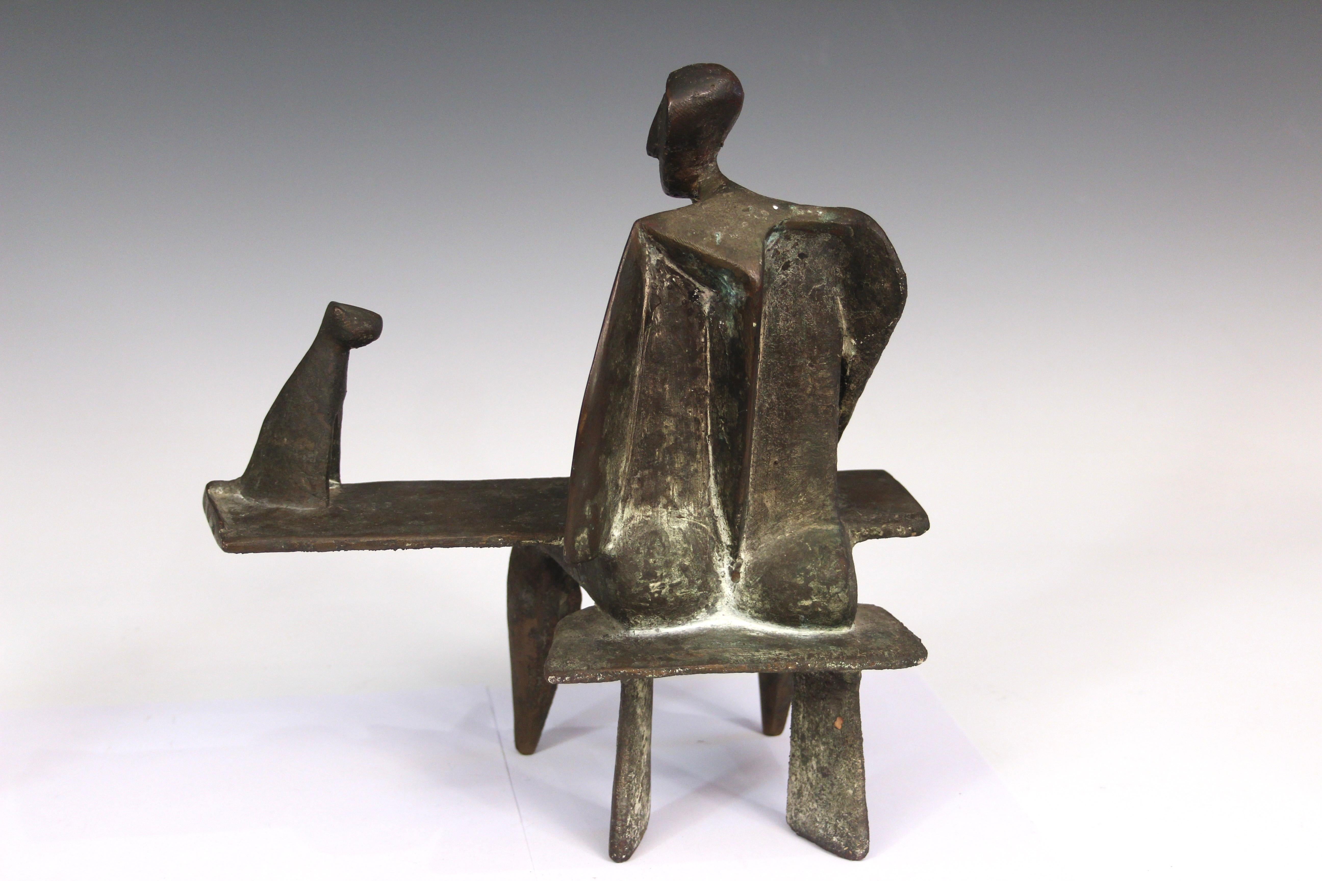 Karl Reidel (German 1927-2006) bronze sculpture of a man sitting at a table with a cat. Signed 