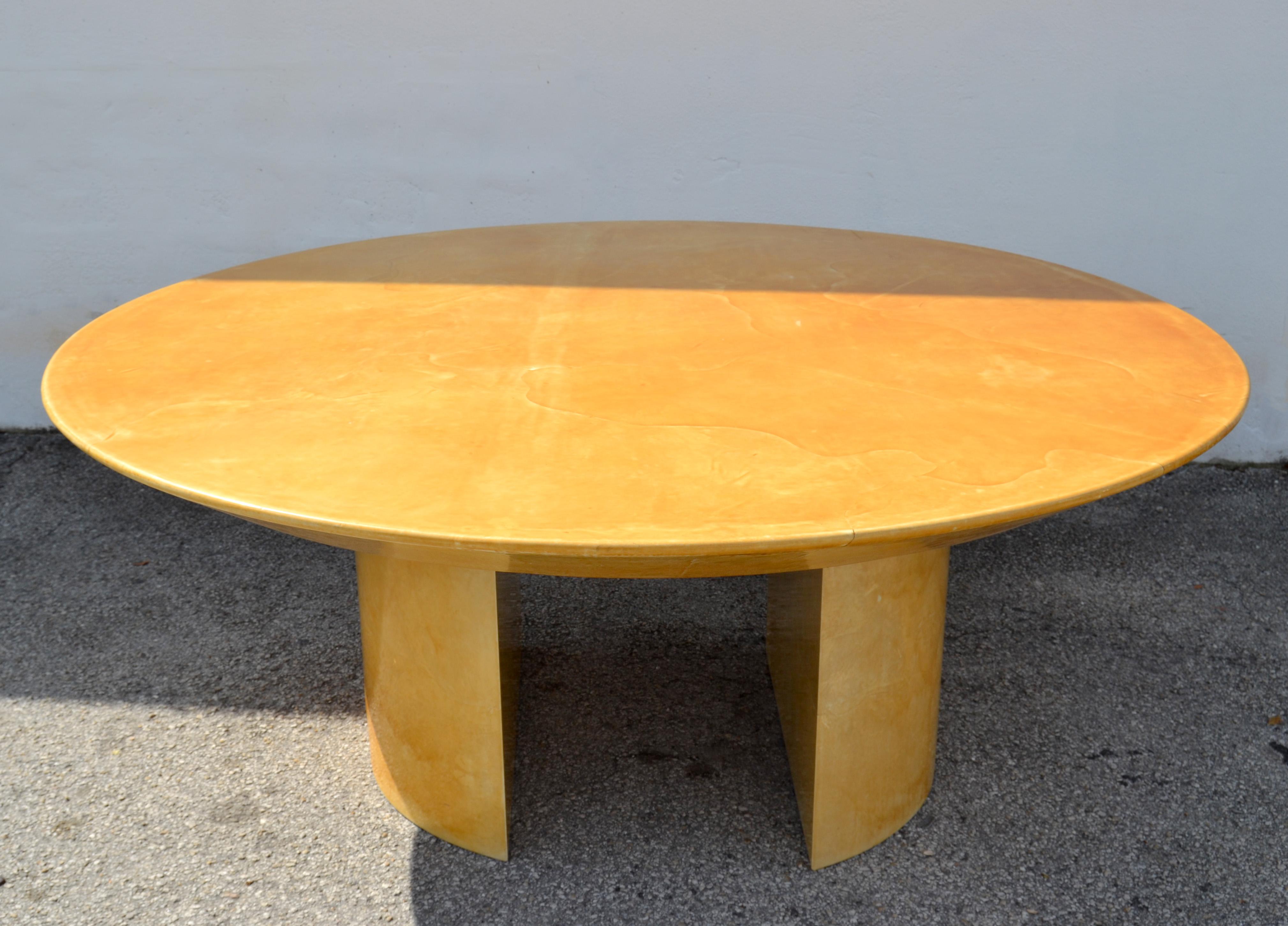 For Sale is this large almost round floating Karl Springer dining table on two half round pedestal bases, made in America in the 1970. 
All wood core decorated with the Goat Skin and lacquered for long lasting beauty.
Original condition with some