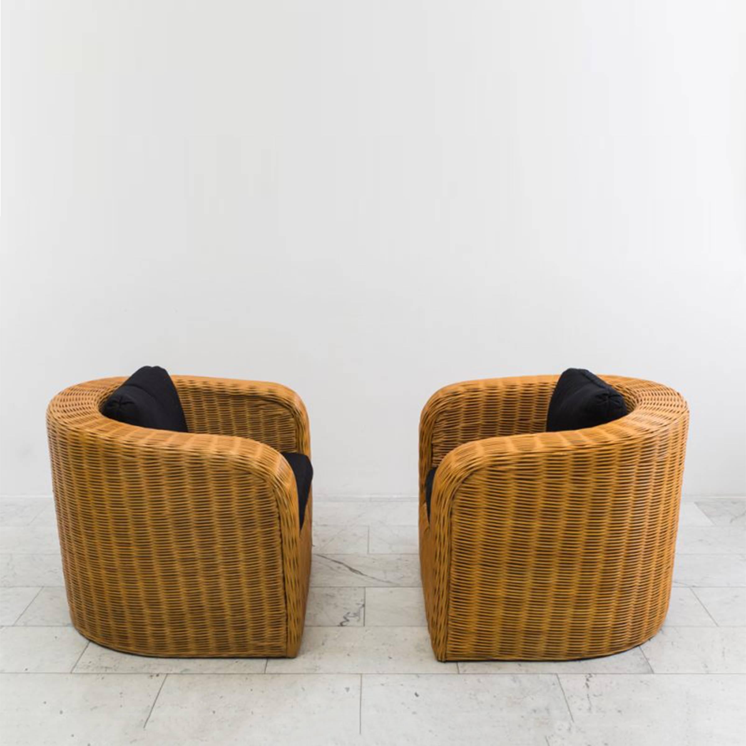 These gorgeous rounded-back Karl Springer Pullman Chairs were designed in 1985.  Constructed of bamboo and wicker the chairs feature Springer’s penchant for simple, elegant lines, excellent craftsmanship and a modern aesthetic. A matching Pullman
