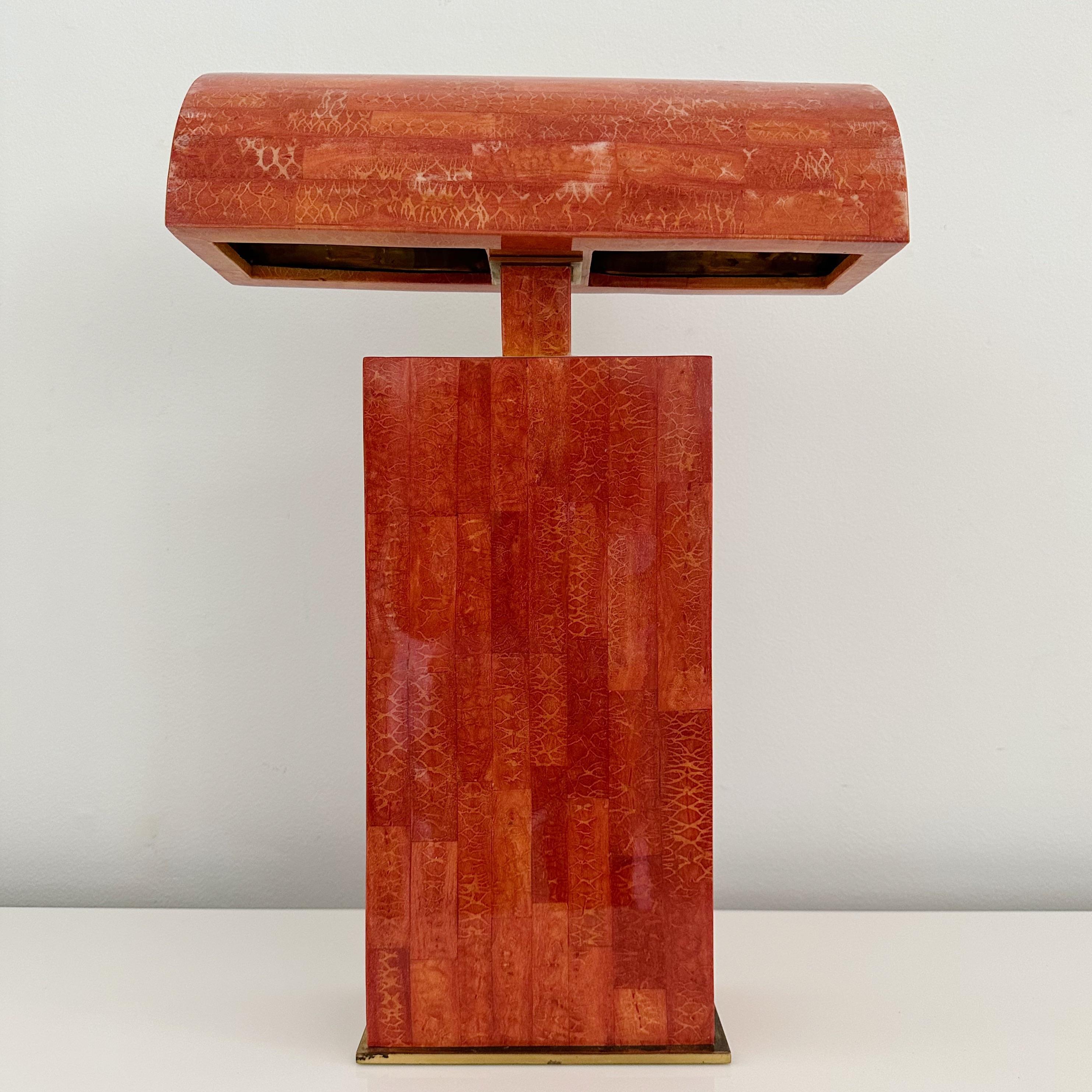 Karl Springer, coral sculpture desk lamp, 24 x 16.5 x 5.5 inches, brass trim and lacquered red coral, sculpture desk lamp made in the Philippines by Paul Maitland Smith for Karl Springer Studio in the 1980s. The attached shade is lined in brass.