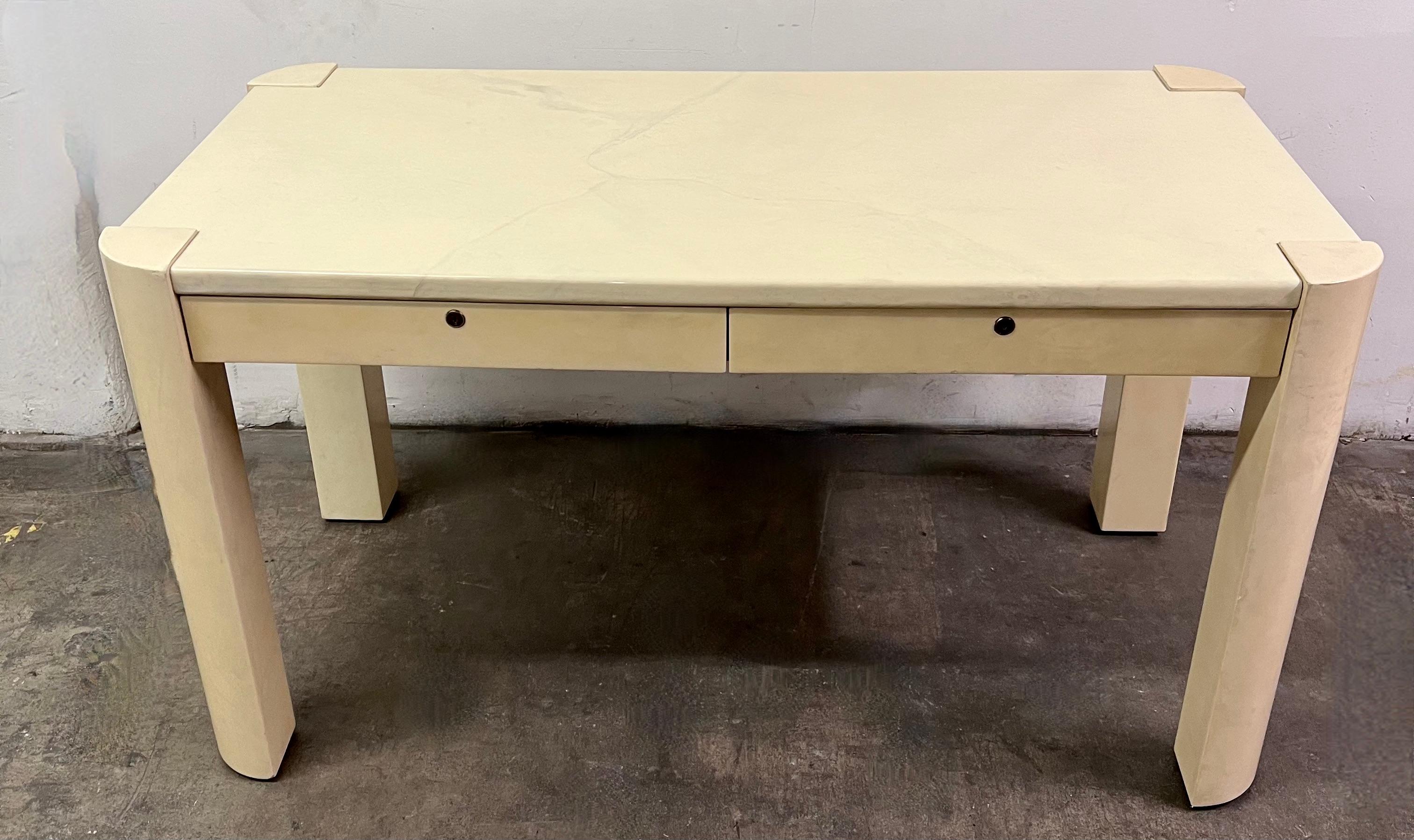 Iconic mid-century Designer, Karl Springer two drawer desk. The Desk is hand crafted of Lacquered Goatskin and has radius legs all meticulously designed for a seamless look. The drawers have the original key are are also finely made with space for