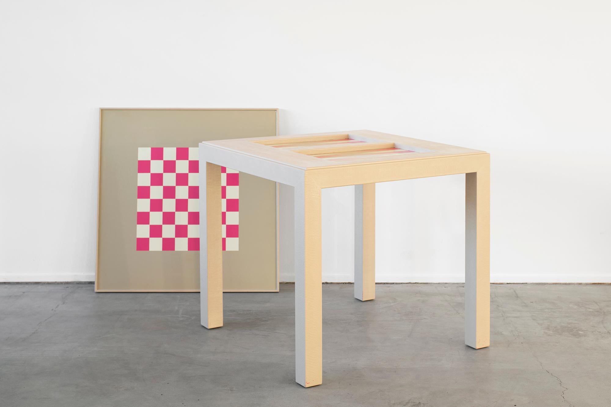 Wonderful gam table with bright pink backgammon or chess boards, attributed to Karl Springer.
Covered in faux-snakeskin with removable top revealing a checkerboard underside and backgammon inset.
Measures: 30in tall x 32in wide x 32in deep.