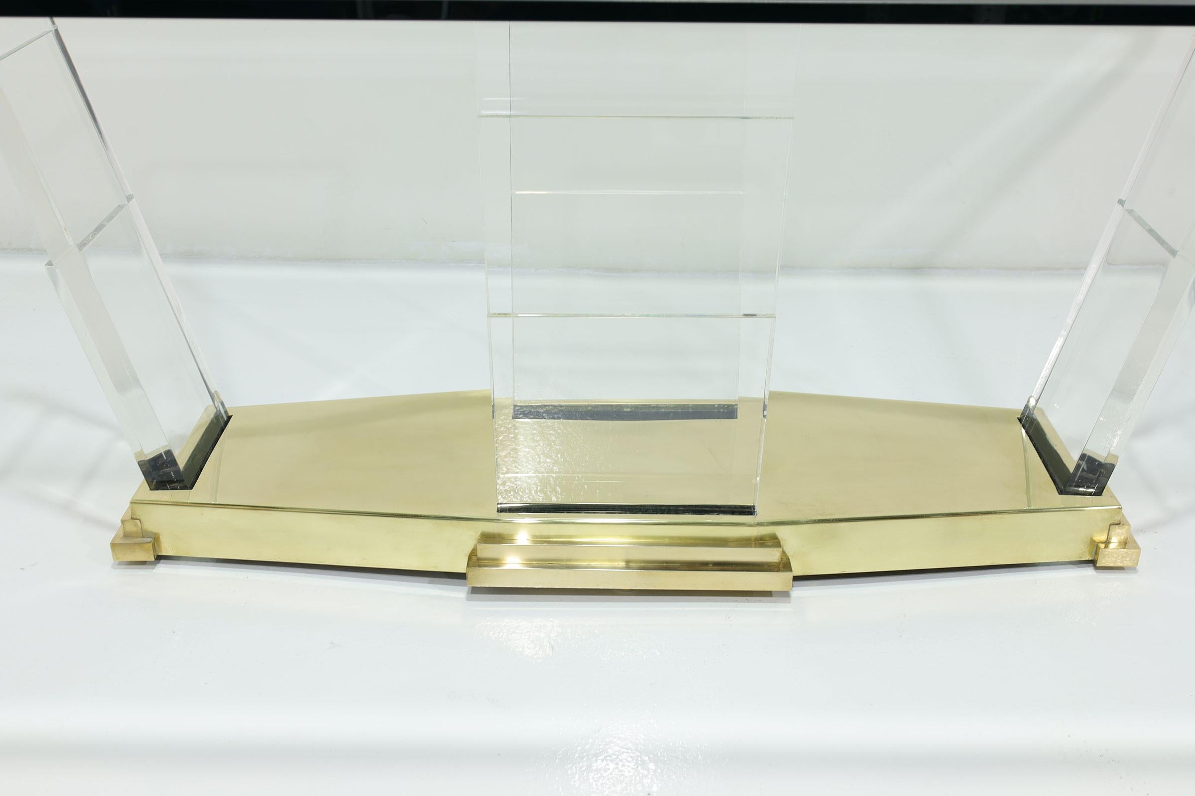 Il s'agit d'une table de salle à manger étonnante pour ceux qui ont un œil avisé pour l'élégance moderne du milieu du siècle. Une lourde base en laiton massif supporte 4 tours Lucite empilées, offrant à la fois durabilité et une touche de