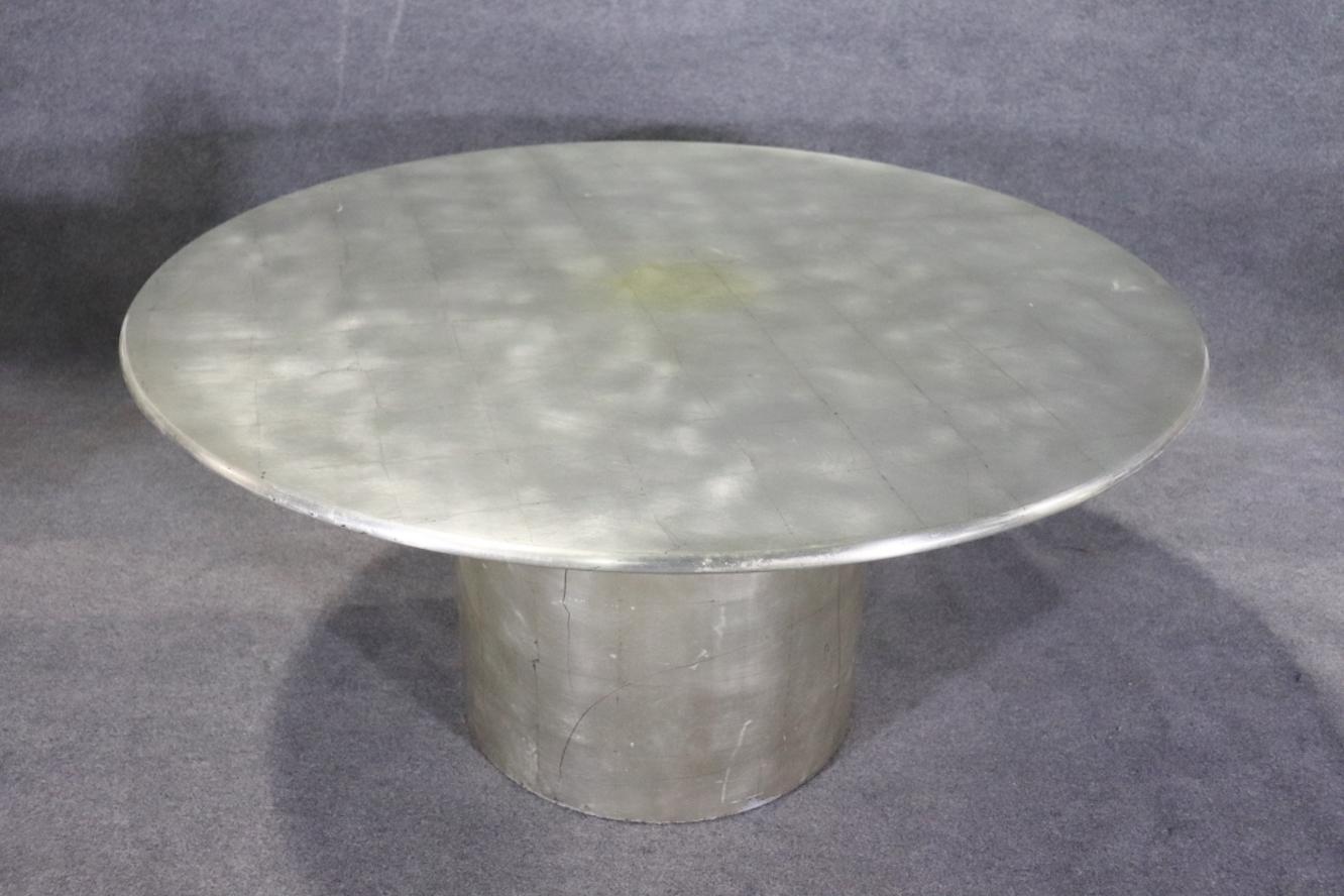Two piece center table wrapped in silver leaf. Gorgeous finish with five foot round top on a pedestal column base.
Please confirm location NY or NJ