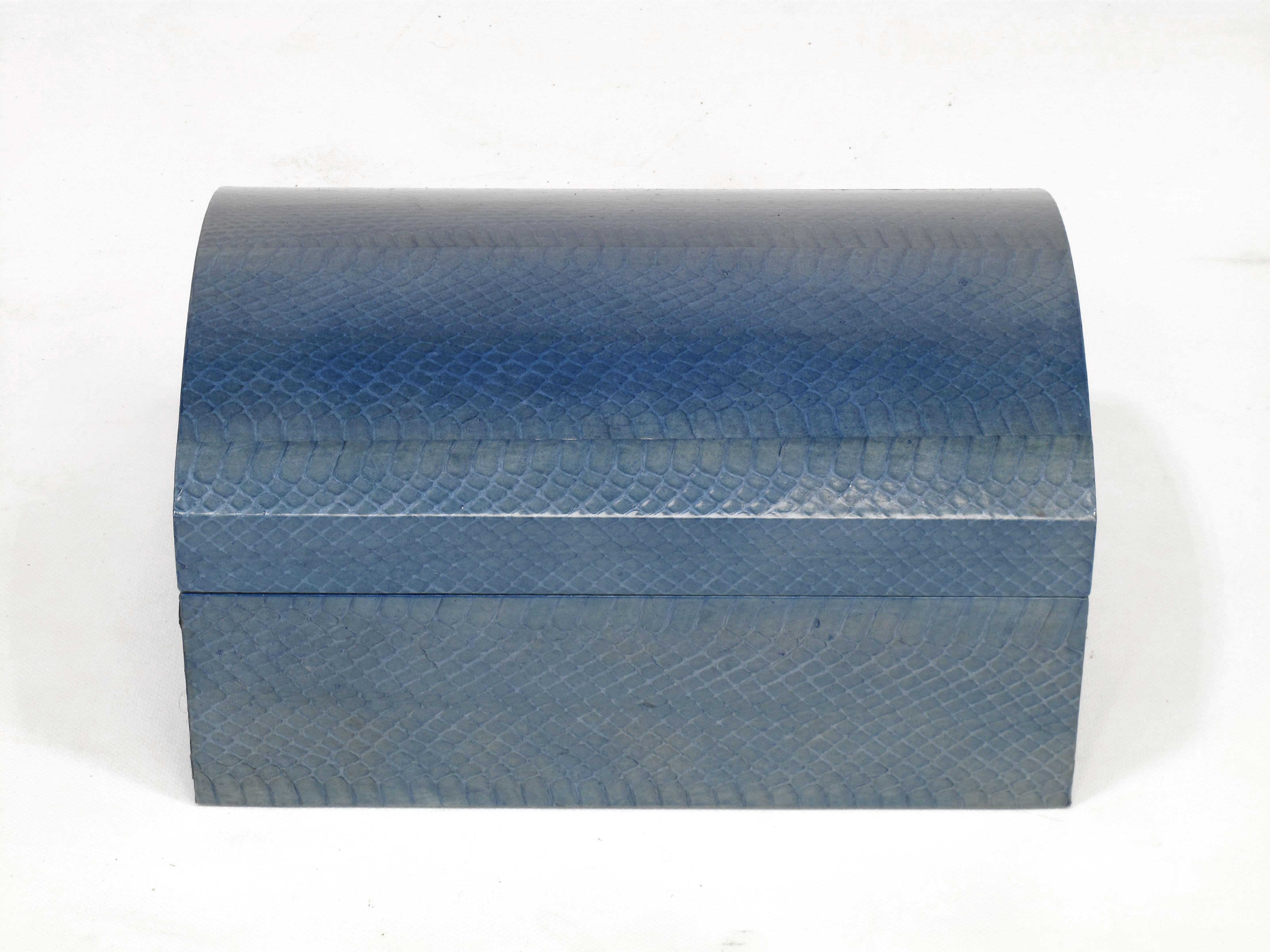 Elegant and edgy python snake skin covered box by Karl Springer. The top is arched and the interior is blue suede. Chrome piano hinge allows the box to open fully. The azure blue python hide has color variation as you would expect from a dyed,