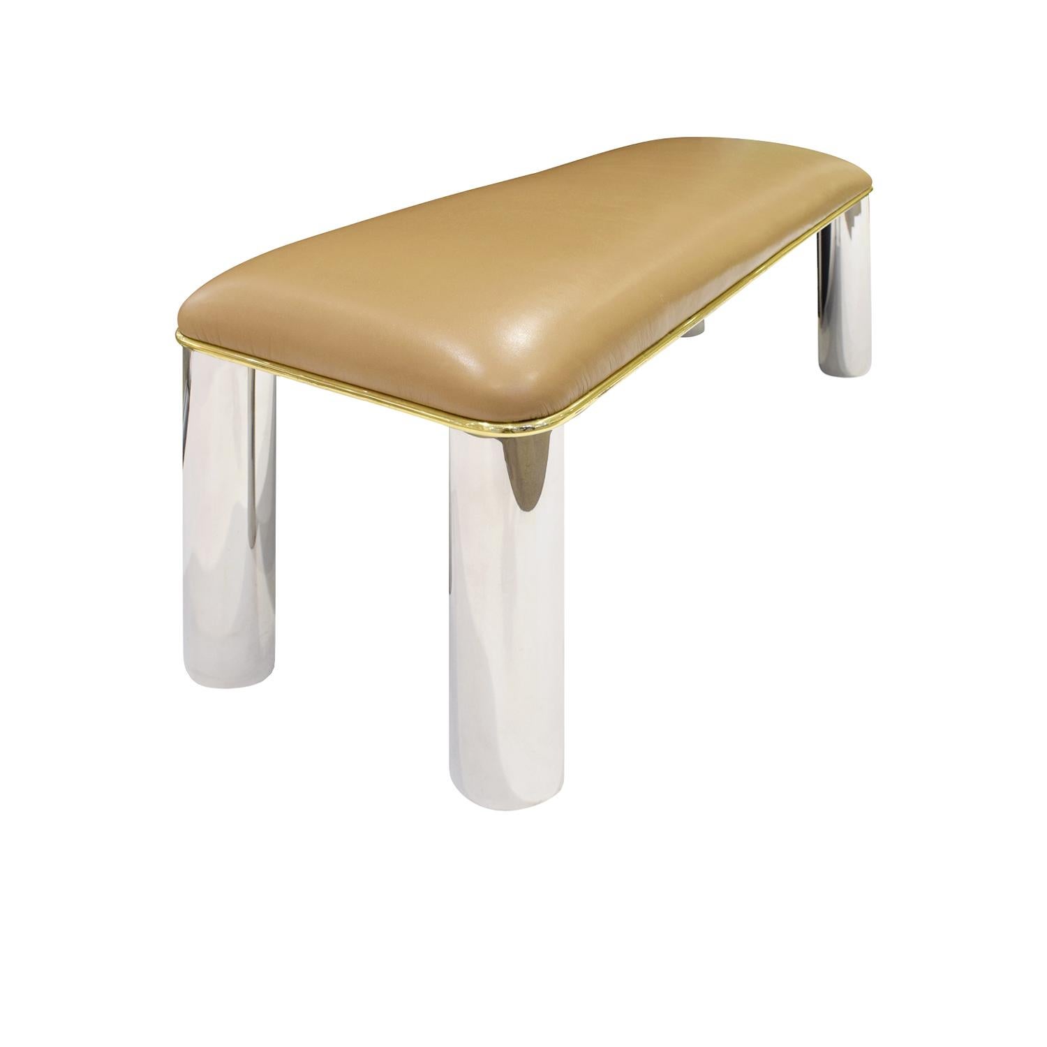 Long bench with base in polished stainless steel with thin brass trim and upholstered seat by Karl Springer, American, 1980s. The seat is currently upholstered in leather.