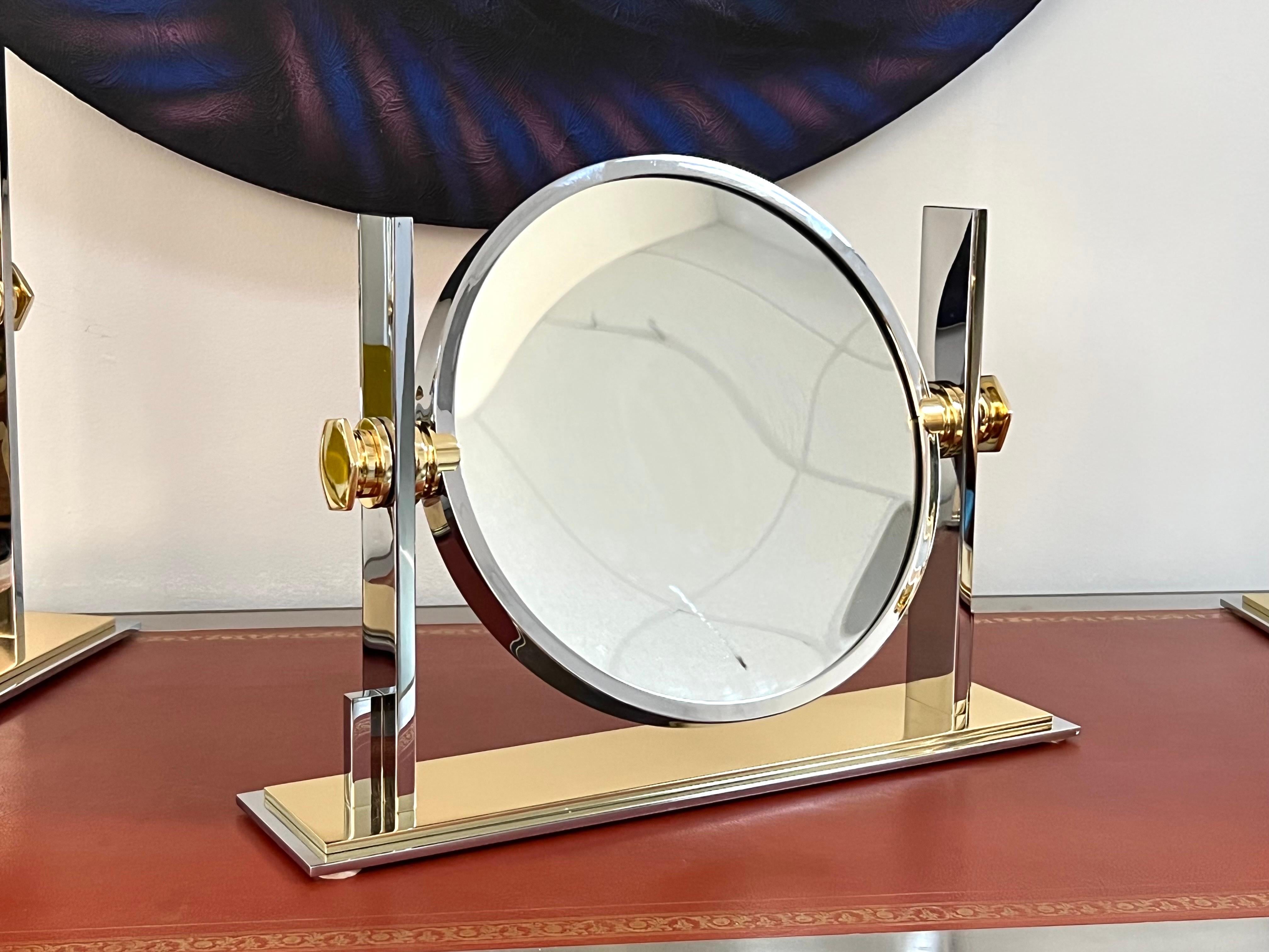 Nice mirror. Vanity or shaving.Brass and nickel. It swivels and one side is magnifying. 