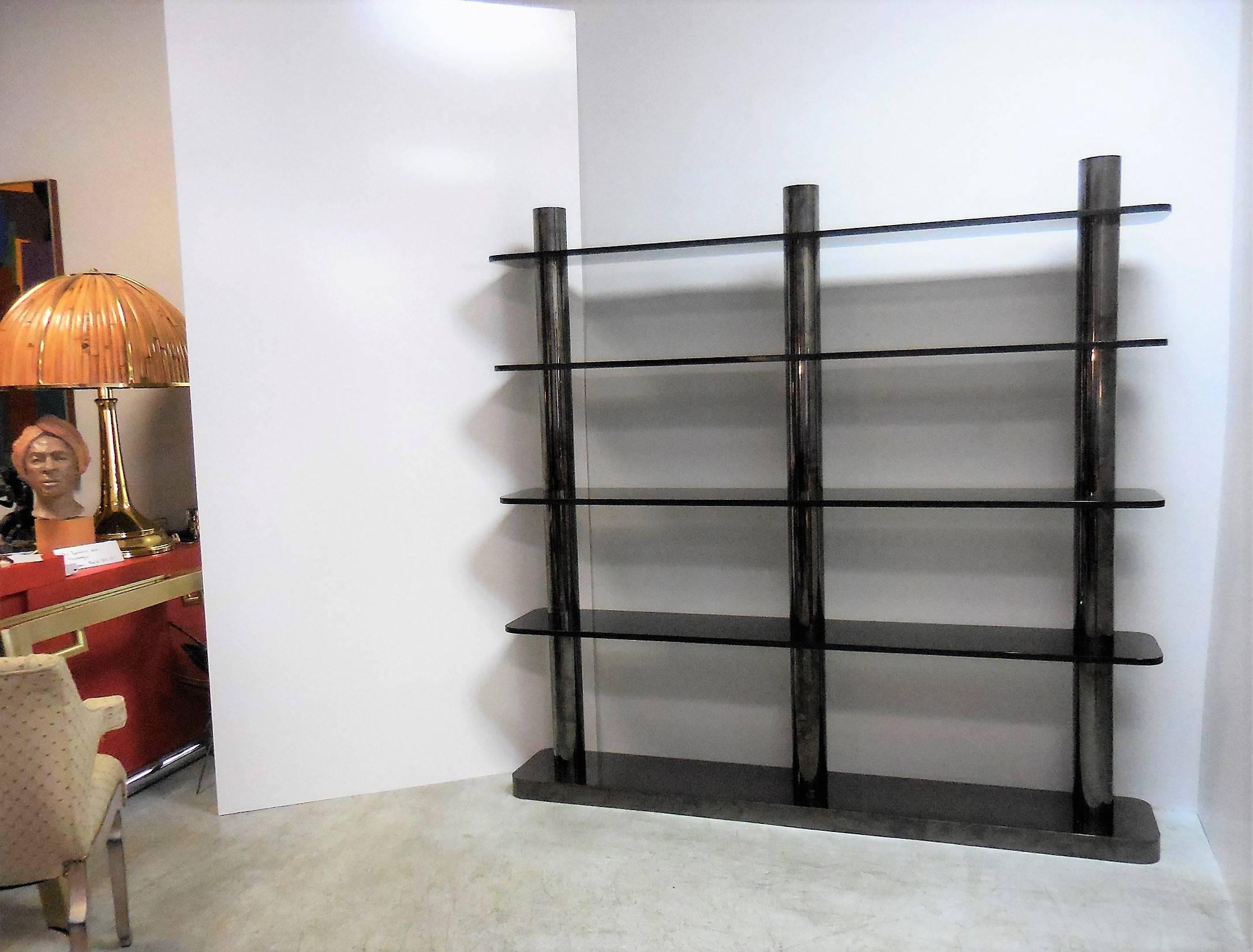 A rare Karl Springer freestanding bookcase or etagere. Bronze columns with gun metal finish and smoked glass shelves. The design is miraculously simple and yet sexy, bold and functional. Certificate of authenticity included.