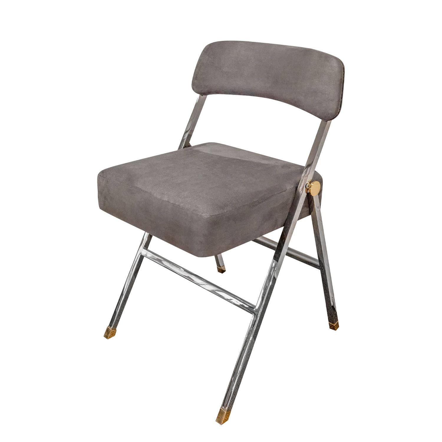Chair, beautifully crafted in polished brass and chrome with upholstered seat and back, by Karl Springer, American 1980's.  Metal has been professionally polished and lacquered and chair has been newly reupholstered in gray ultrasuede by Lobel