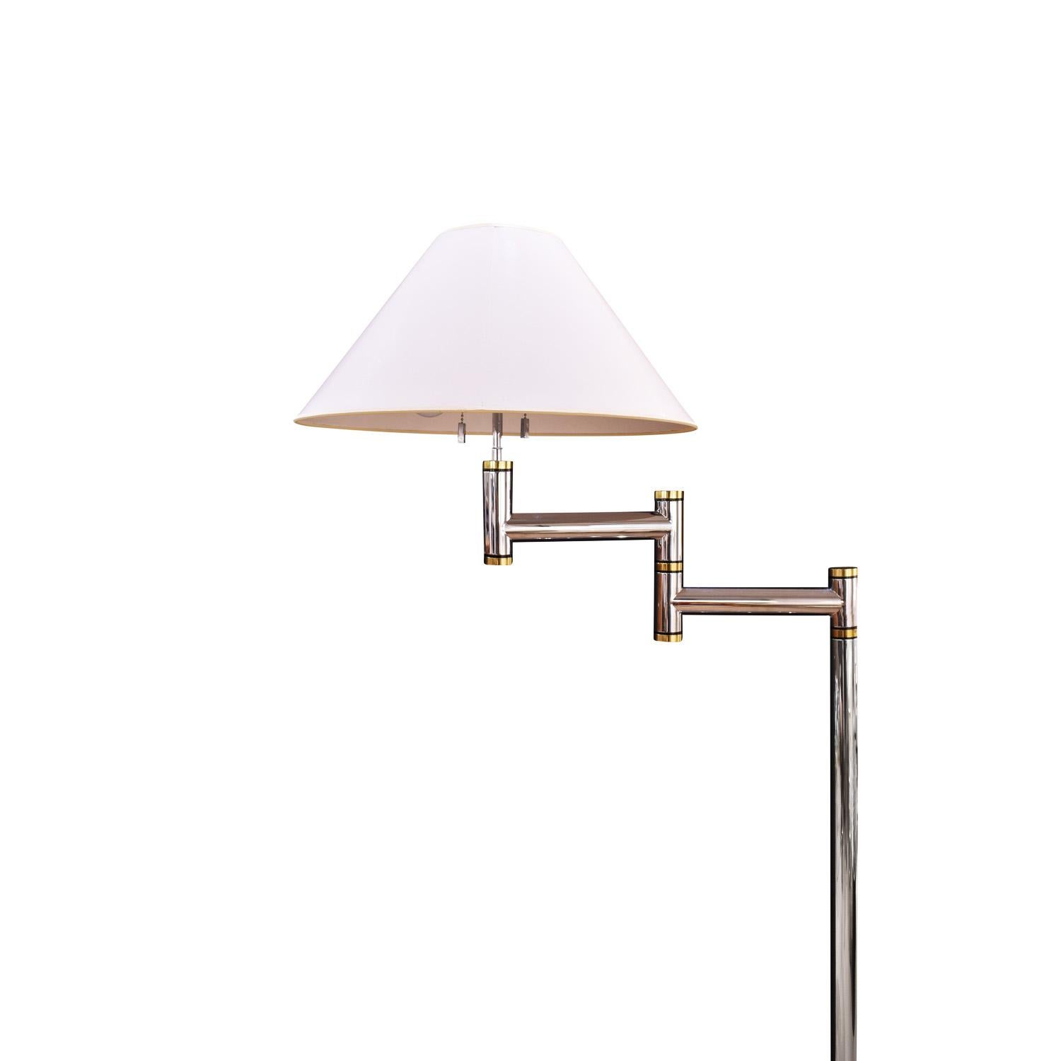 Meticulously crafted swing-arm floor lamp in polished chrome and brass by Karl Springer, American 1980's. This listing is for 1 lamp; 1 has sold. The quality of construction of these lamps is incredible. With original white lacquered shade.

For