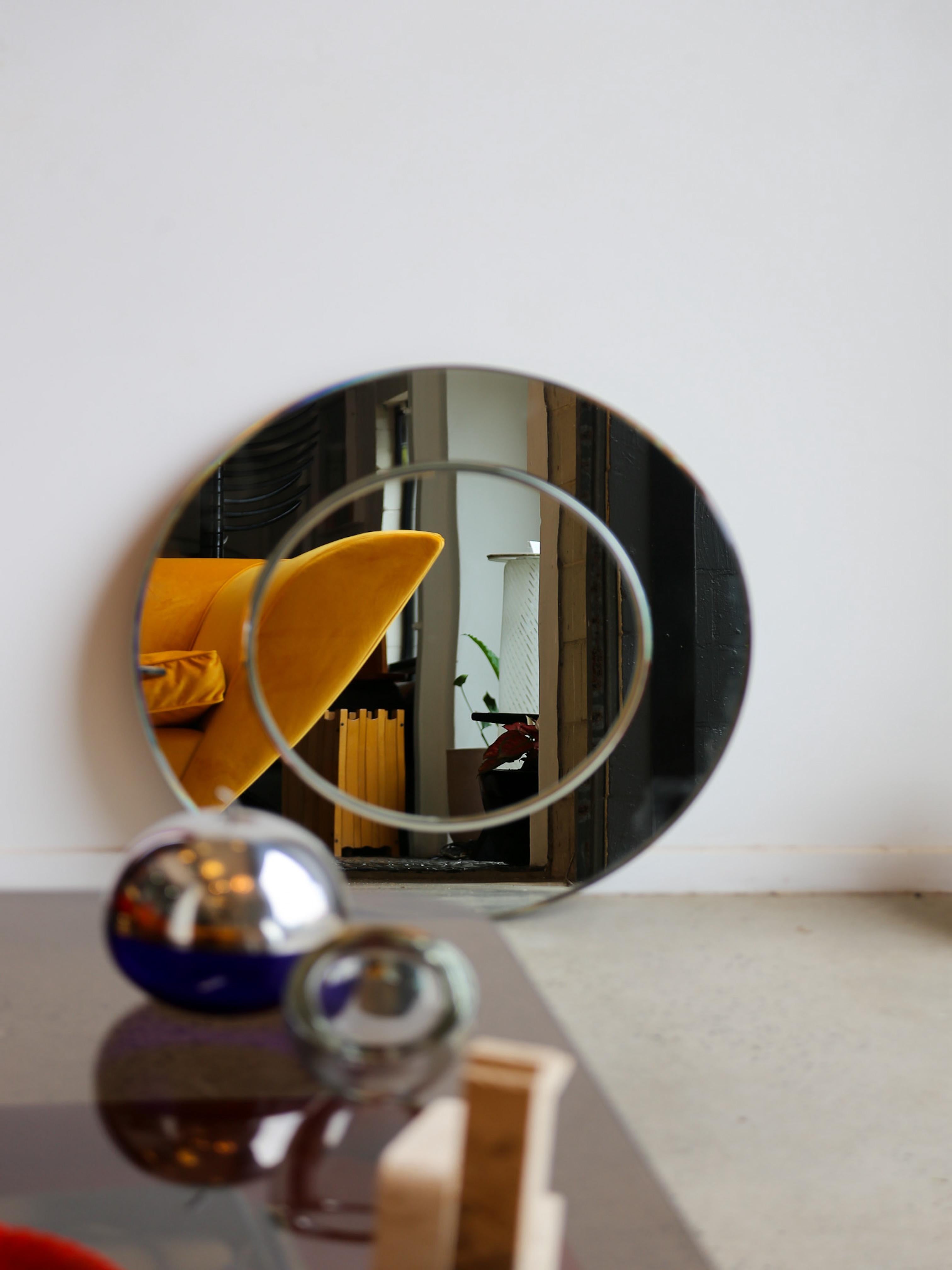 Round wall mirror is designed in the style of Karl Springer, known for his luxurious and sculptural aesthetic. The mirror features a double-layered circular design, with an elegant floating inner ring that adds depth and dimension.
Crafted with
