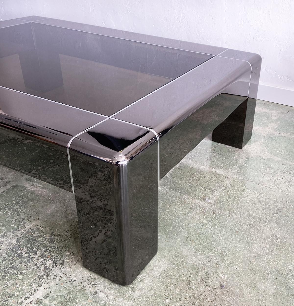 Karl Springer cocktail or coffee table in gunmetal and polished steel 1980s In excellent, like-new condition, parsons style with smoked glass. Black oxide reflective finish with rare polished stainless steel banding accents. One of the finest we've