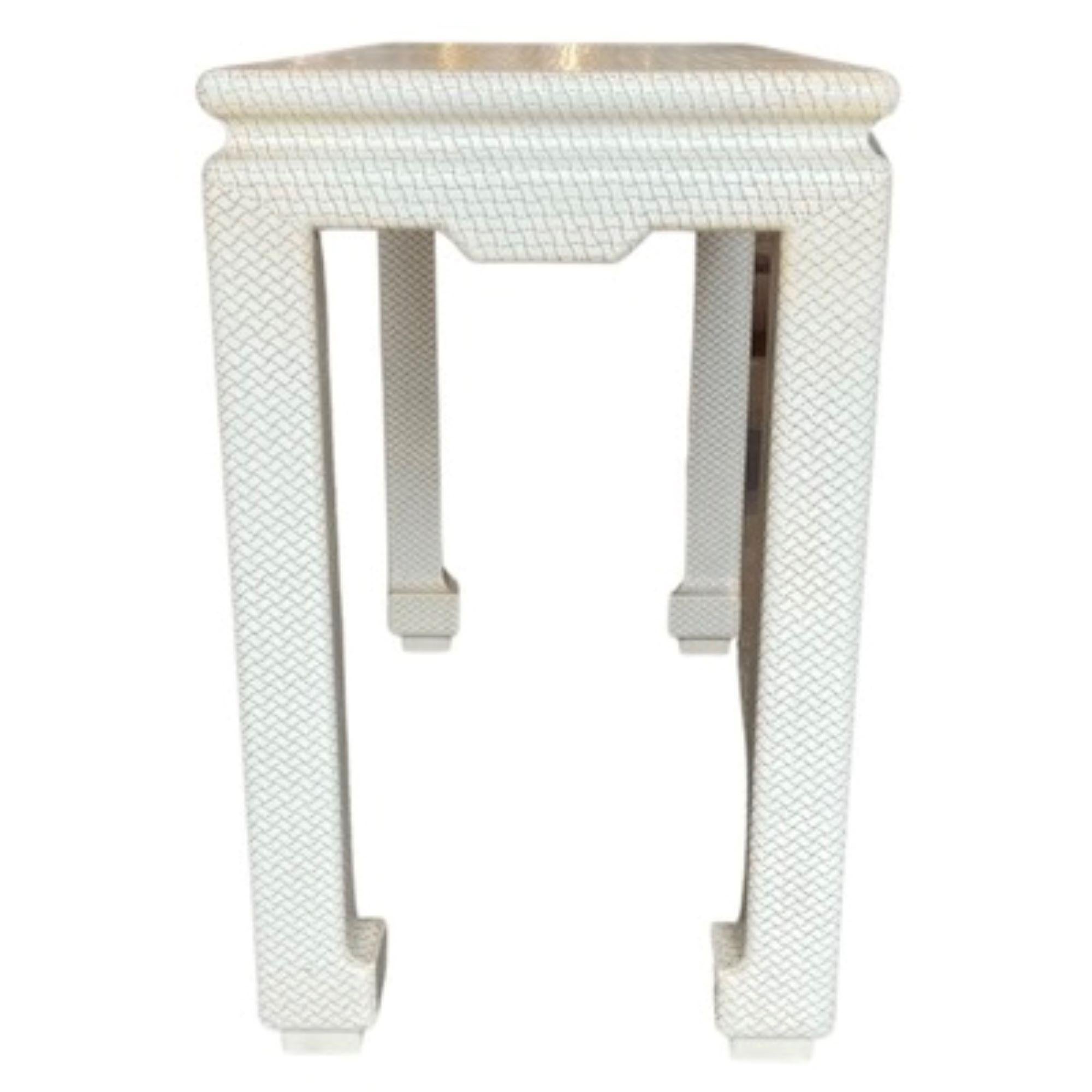 Beautiful ivory tone console table.
Wood base with woven overlay textured finish
Very unique creation by Karl Springer
Made in the USA
1970's
Rectangular legs featuring extended feet
Vintage
Mid-Century Modern
This petit console table is a