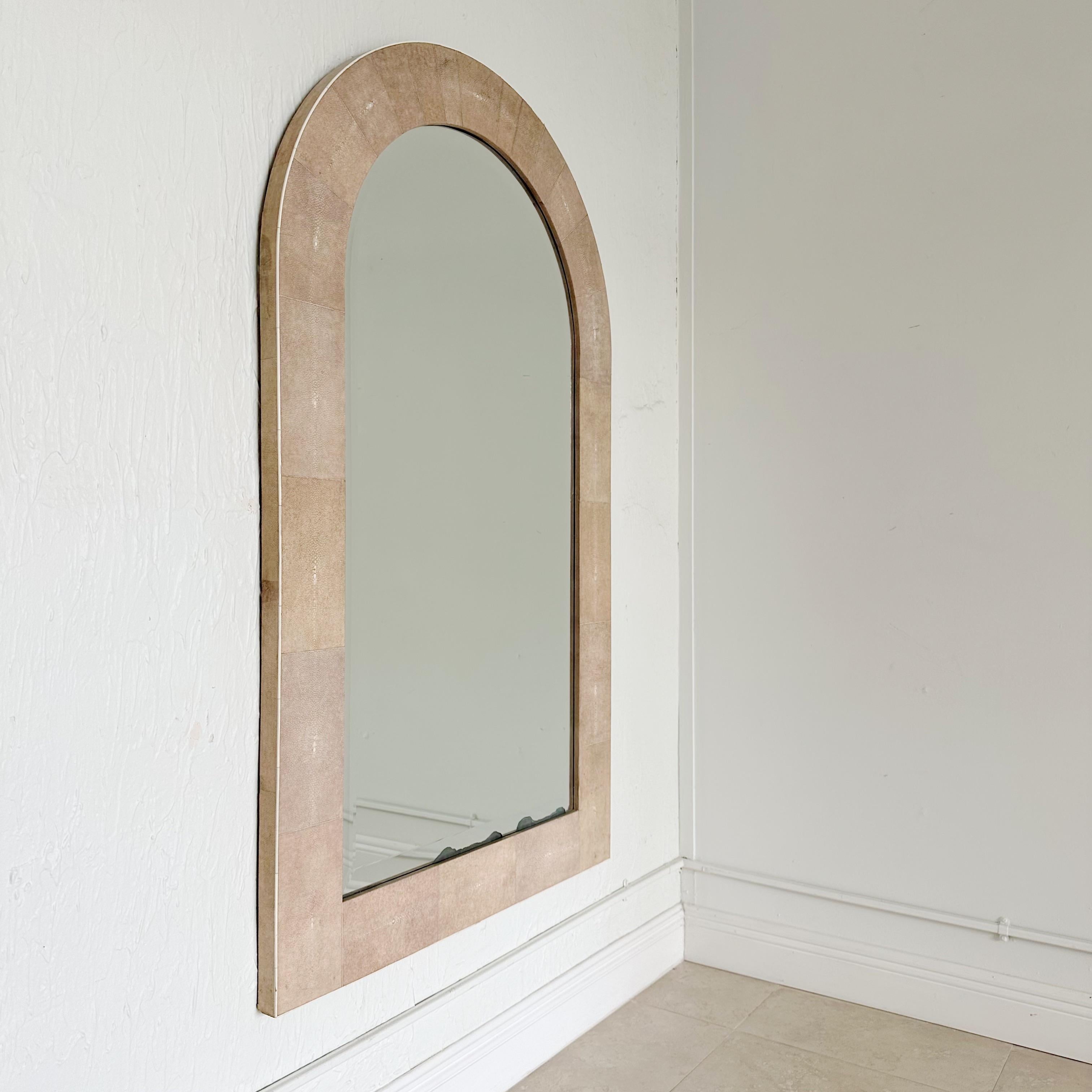 Large vintage Taupe colored shagreen mirror with bone inlay, by Karl Springer circa 1980's. Shagreen covered wood frame surrounding beveled mirror. Some of the mirror shows silvering loss to bottom edge.