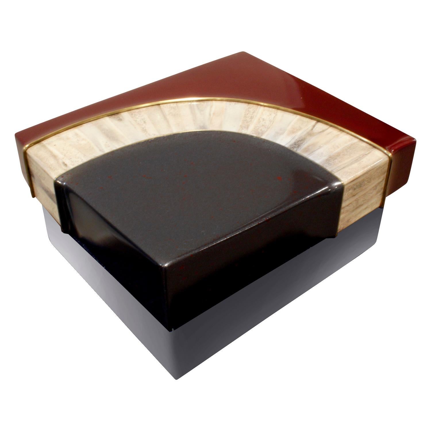 Exceptional box with sculptural cover in red and black glazierite with bone and brass accents, base in stainless steel and interior in burgundy suede by Johnson and Marcius for Lorin Marsh, 1980s.  Johnson and Marcius made special pieces which were