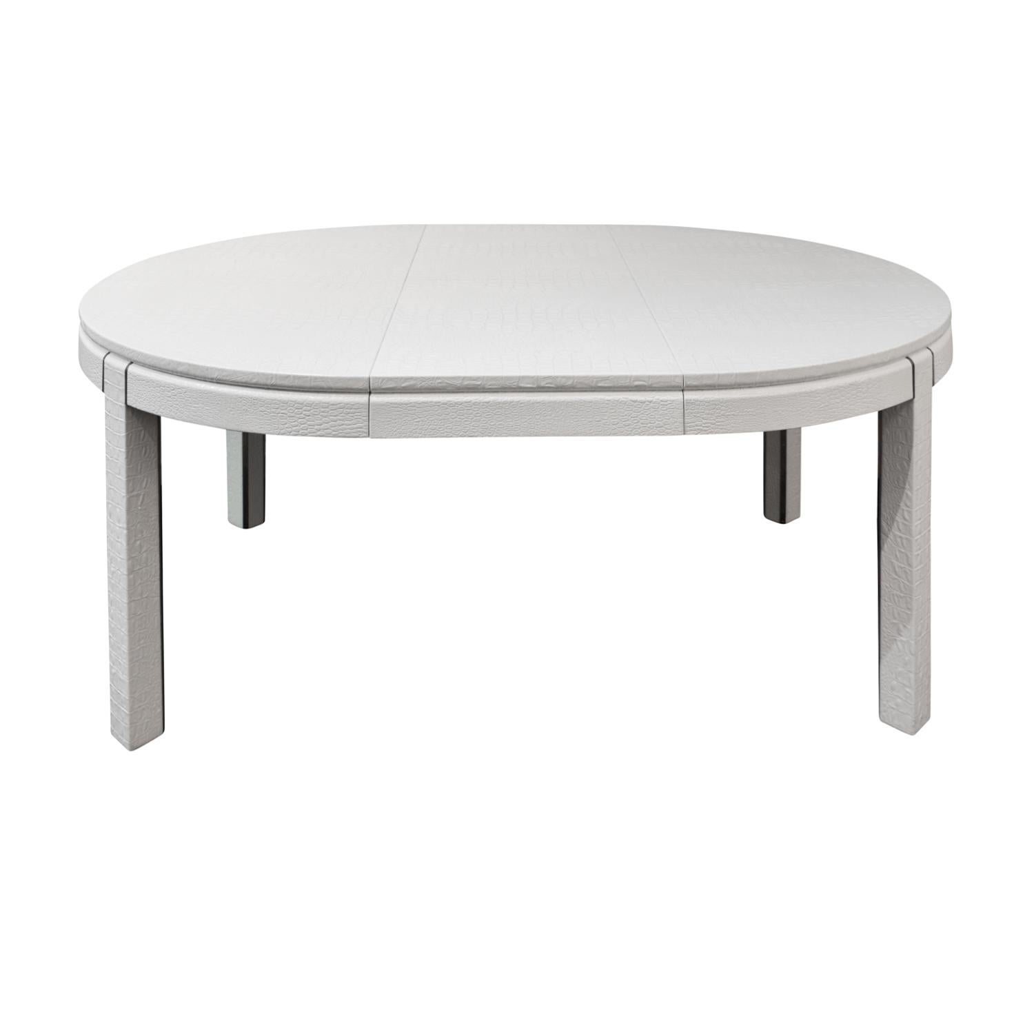 Round extension dining table with 3 leaves covered in white embossed crocodile leather with chrome accents by Karl Springer, American, 1980's. It is rare to see a Springer extension table that expands so large. It’s meticulously made in the finest