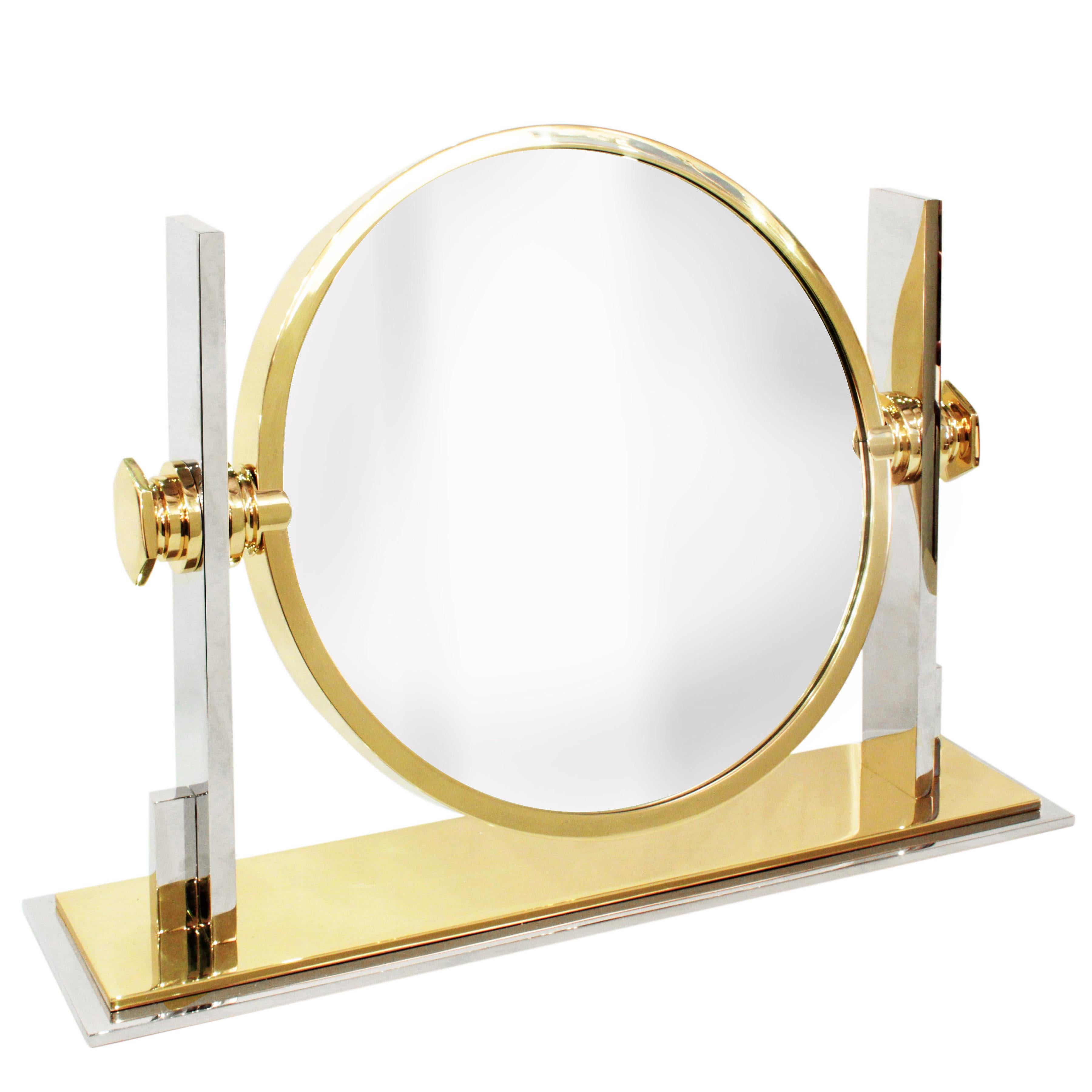 Meticulously crafted extra large vanity/dressing table mirror in polished steel and brass with magnifier on one side and standard mirror on the other by Karl Springer, American 1980's. This one is larger than the ones which are usually offered for