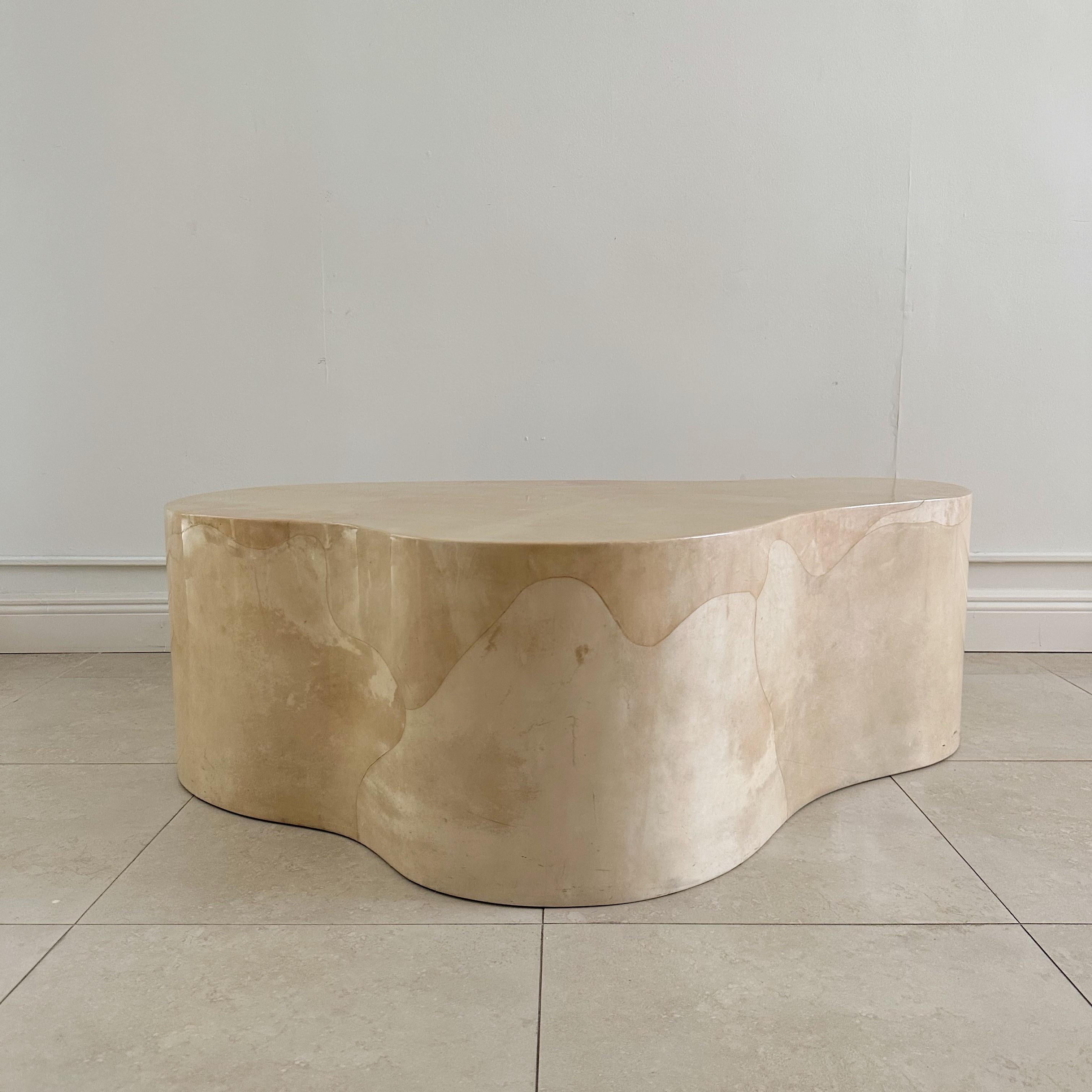 Karl Springer biomorphic freeform table, crafted in the 1980s, showcases Springer's mastery in harmonizing organic shapes with impeccable craftsmanship. The table is expertly covered in a lavish cream and beige-colored goatskin lacquer. Its smooth