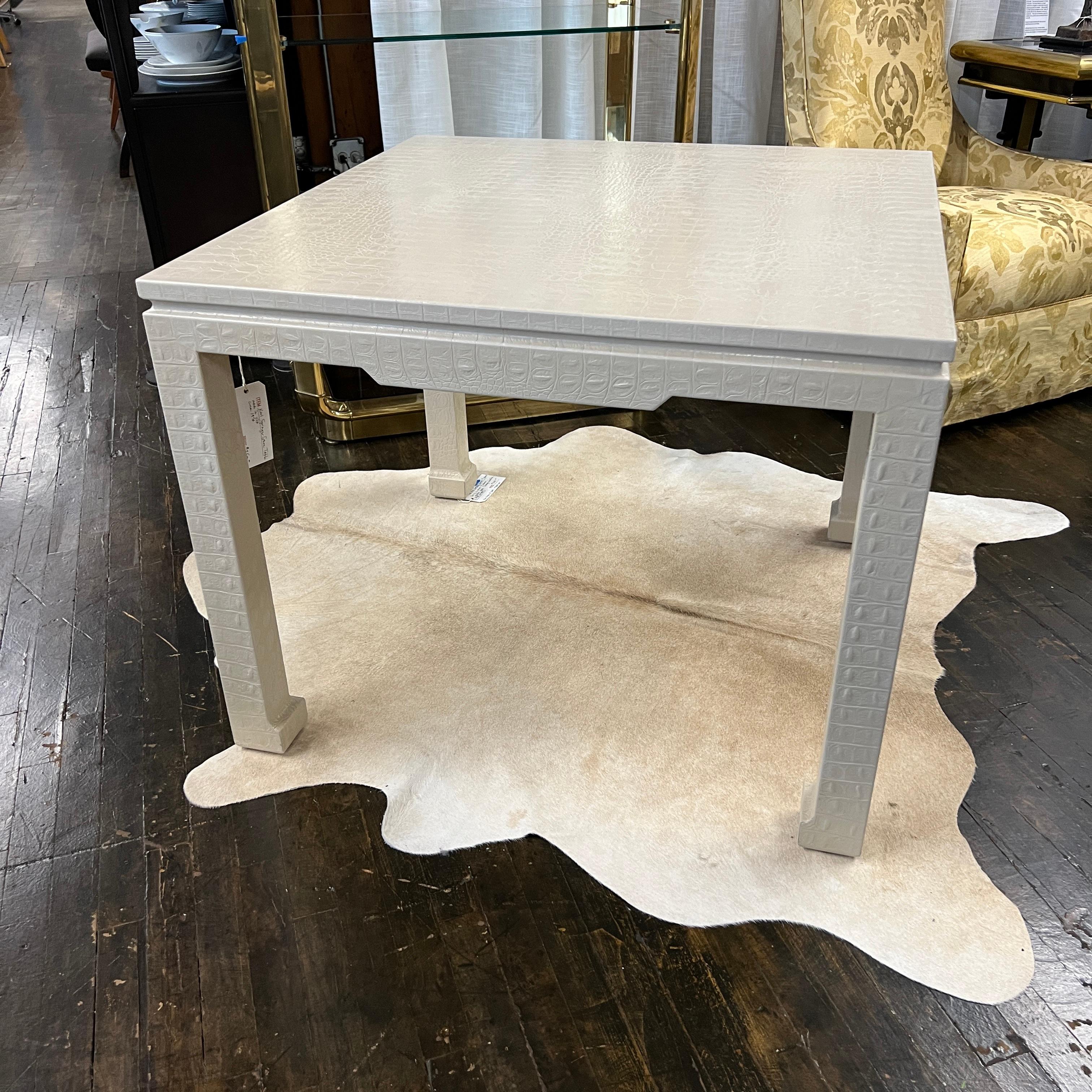 Stunning square Chinoiserie from game table by Karl Springer.  The table is wrapped in an ivory (or a very light tan) embossed leather that simulates crocodile.  The table is stunning.  There is some light wear at the feet (where the leather was