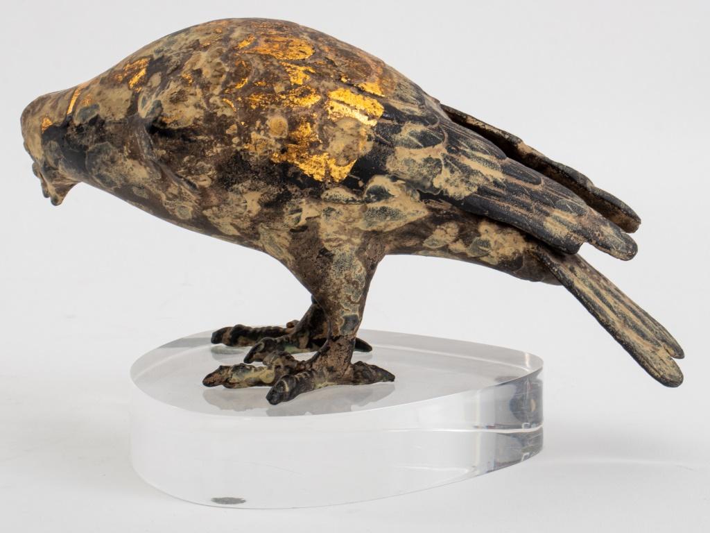 Cast iron bird decorated with a strip of gold leaf,  mounted on a custom lucite base made by Karl Springer (American, 1931 - 1991), unmarked. 5