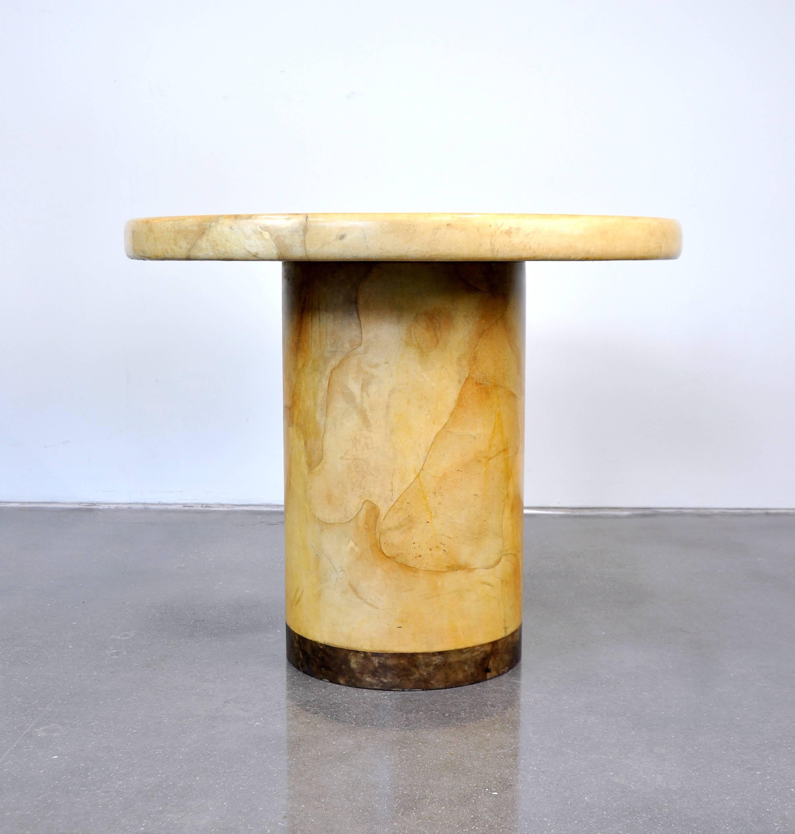 A vintage Mid-Century Modern lacquered goatskin accent table with circular top and two-tone cylindrical base. A wonderful gueridon that could also be used as a dining or breakfast table in smaller spaces, as a card or tea table, or in an entrance,