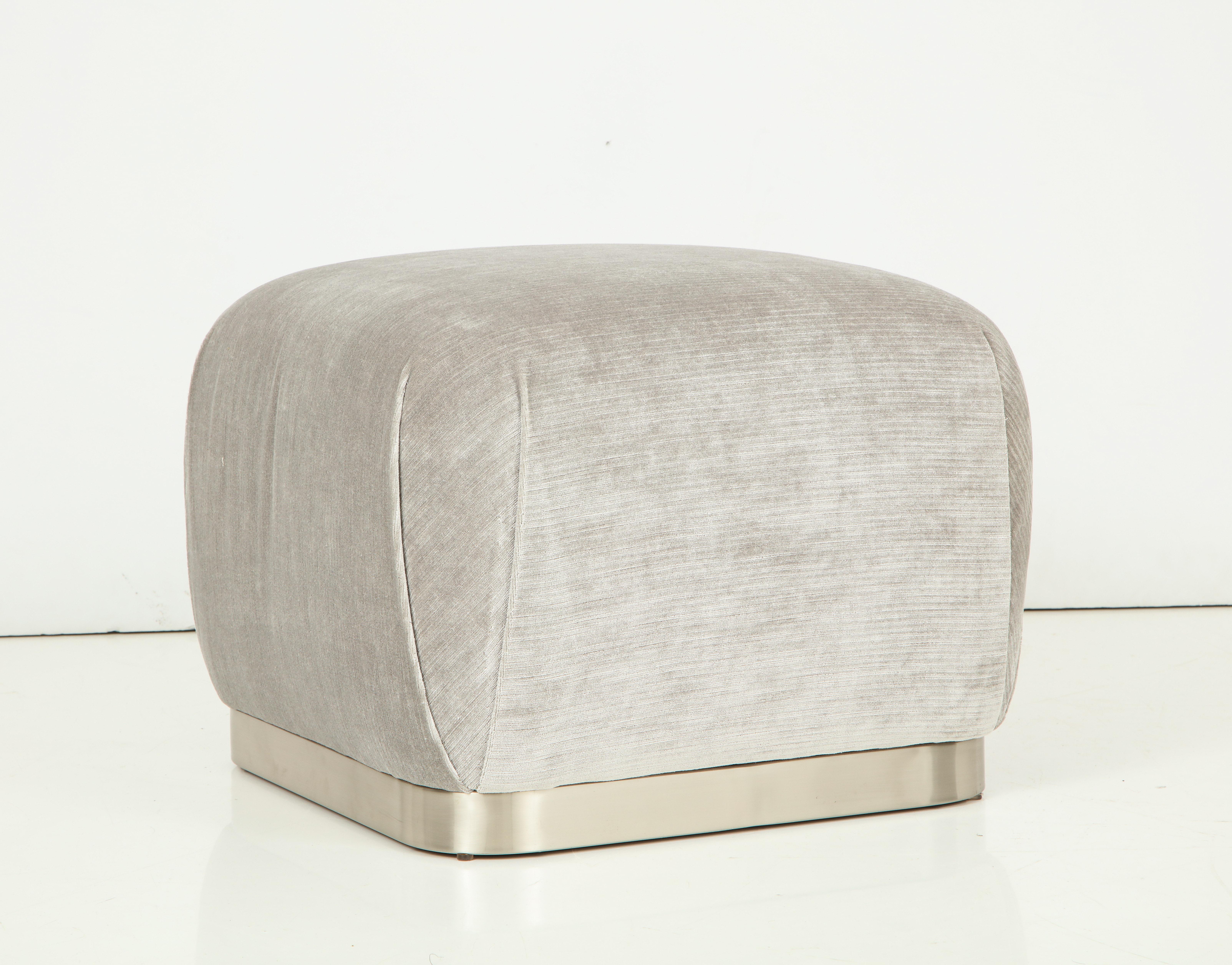 Pair of modernist ottomans newly upholstered in a Romo steel grey velvet with satin finished steel/nickel bases.